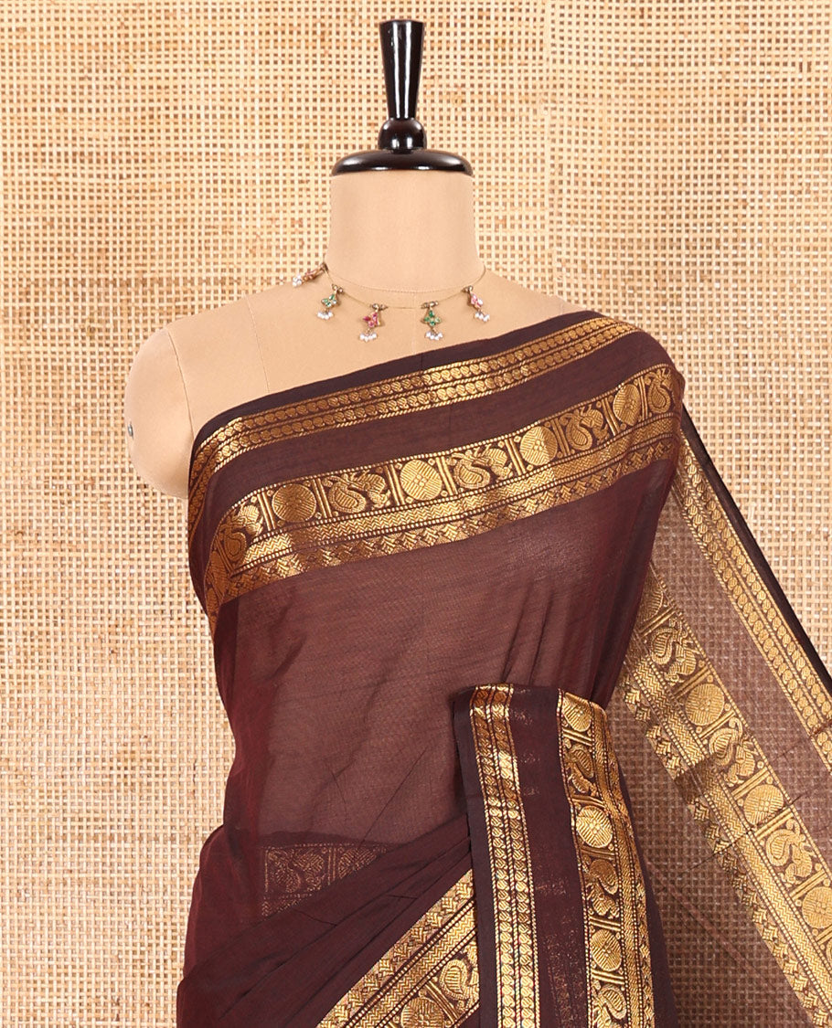 Coffee Brown Plain Chettinad Cotton Saree Elevated with a Gleaming Zari Rettai Pettu Border Featuring Peacock, Rudraksham, and Manga Designs, Subtly Striped Pallu, and Paired with a Matching Blouse