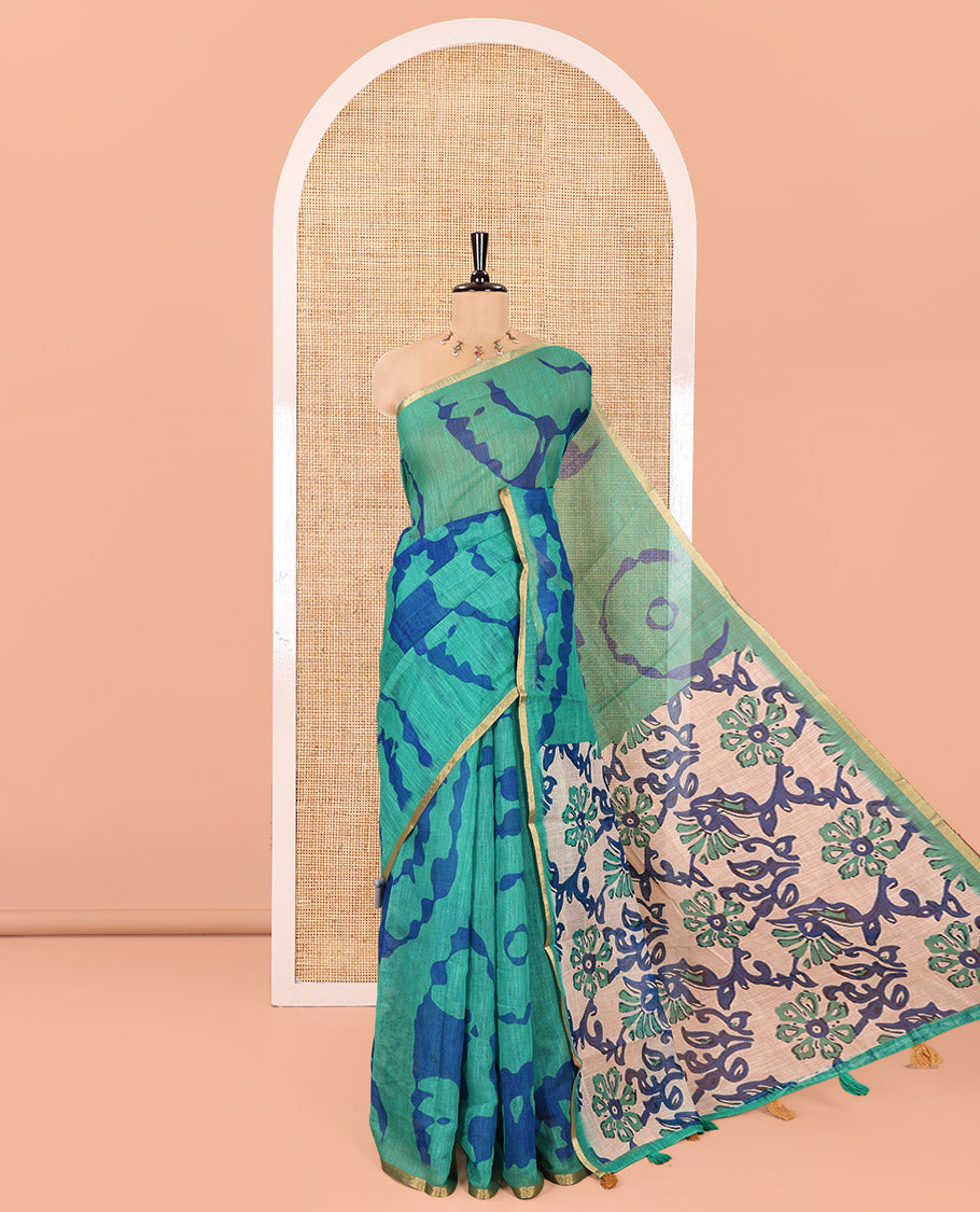 Green Linen Cotton Saree, Adorned with Shibori Printed on Its Body, Subtle Piping Border, Pallu of Floral Vine Print, and Paired with a Contrast Floral Vine Printed Blouse