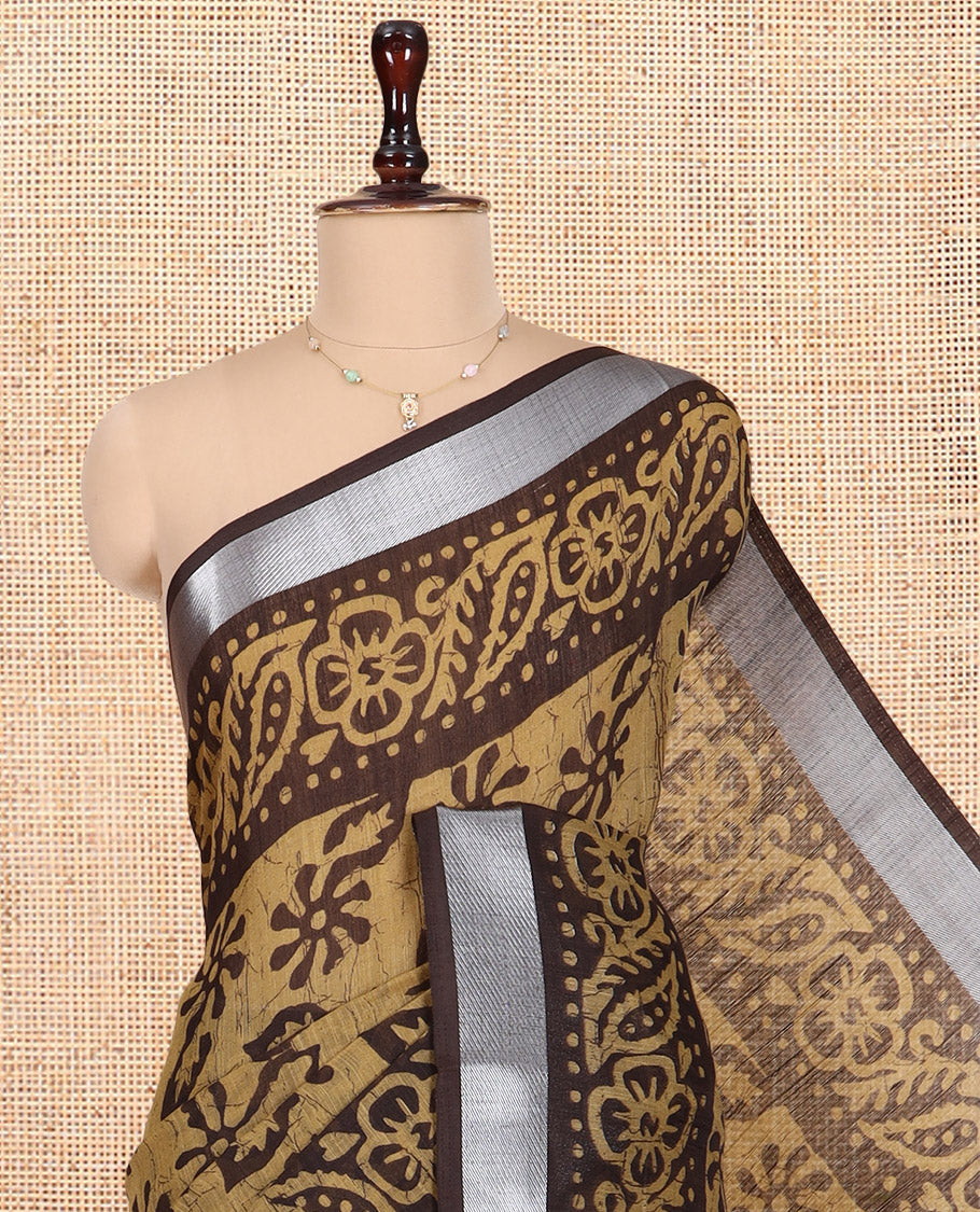 Chikku Jute Linen Saree Features Batik Floral Print, Zari Border, Printed Pallu, Contrast Blouse
