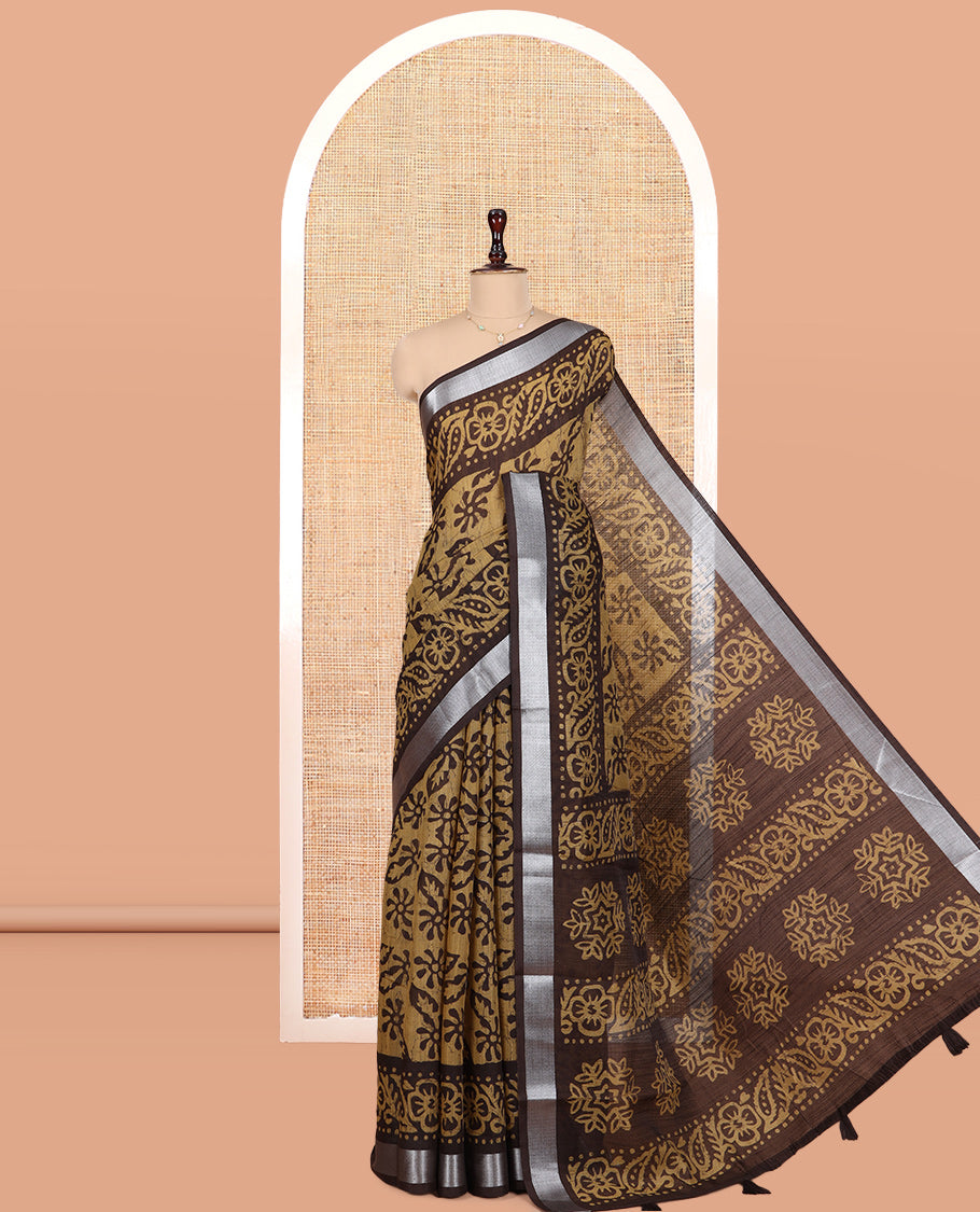 Chikku Jute Linen Saree Features Batik Floral Print, Zari Border, Printed Pallu, Contrast Blouse