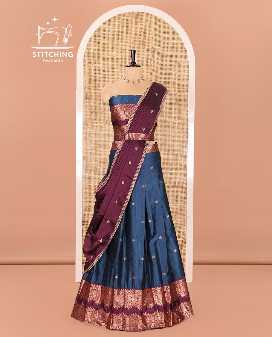 Peacock Blue and Purple Semi-Banarasi Half-Saree Elevated with Zari Buttas on Its Skirt, Complemented by Contrast Traditional Zari Border of Chakram Designs, Paired with a Matching Blouse, and a Satin Georgette Embroidered Scallop Dhavani