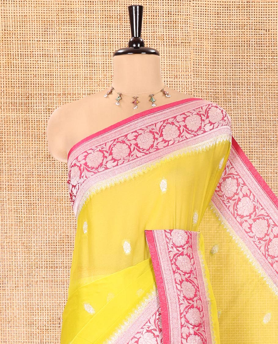 Green Banaras Fancy Georgette Saree, Decorated with Zari Buttas All Over Its Body, Complemented by a Contrast Floral Creeper Zari Border, Pallu Features Paisley Designs, and Paired with a Contrast Blouse