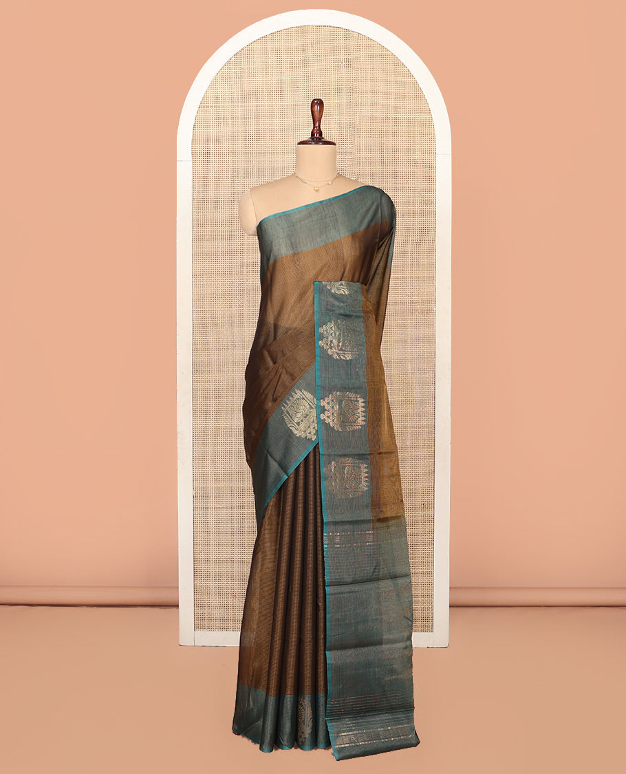 Brown Silk Cotton Saree, Decorated with Buttas All Over Its Body, Complemented by Contrast Border of Parrot Chariot Designs, Temple Pallu, and Paired with a Contrast Blouse