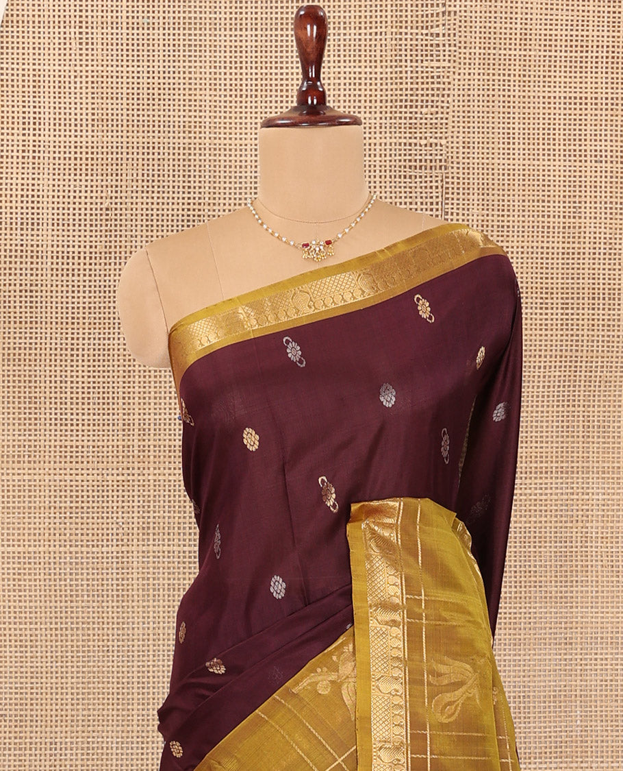 Maroon Uppada Silk Saree Elevated with Zari Buttas All Over Its Body, Complemented by Contrast Traditional Border of Peacock Veenai Designs, Sparsely Woven Pallu of Floral Designs, and Paired with a Contrast Blouse