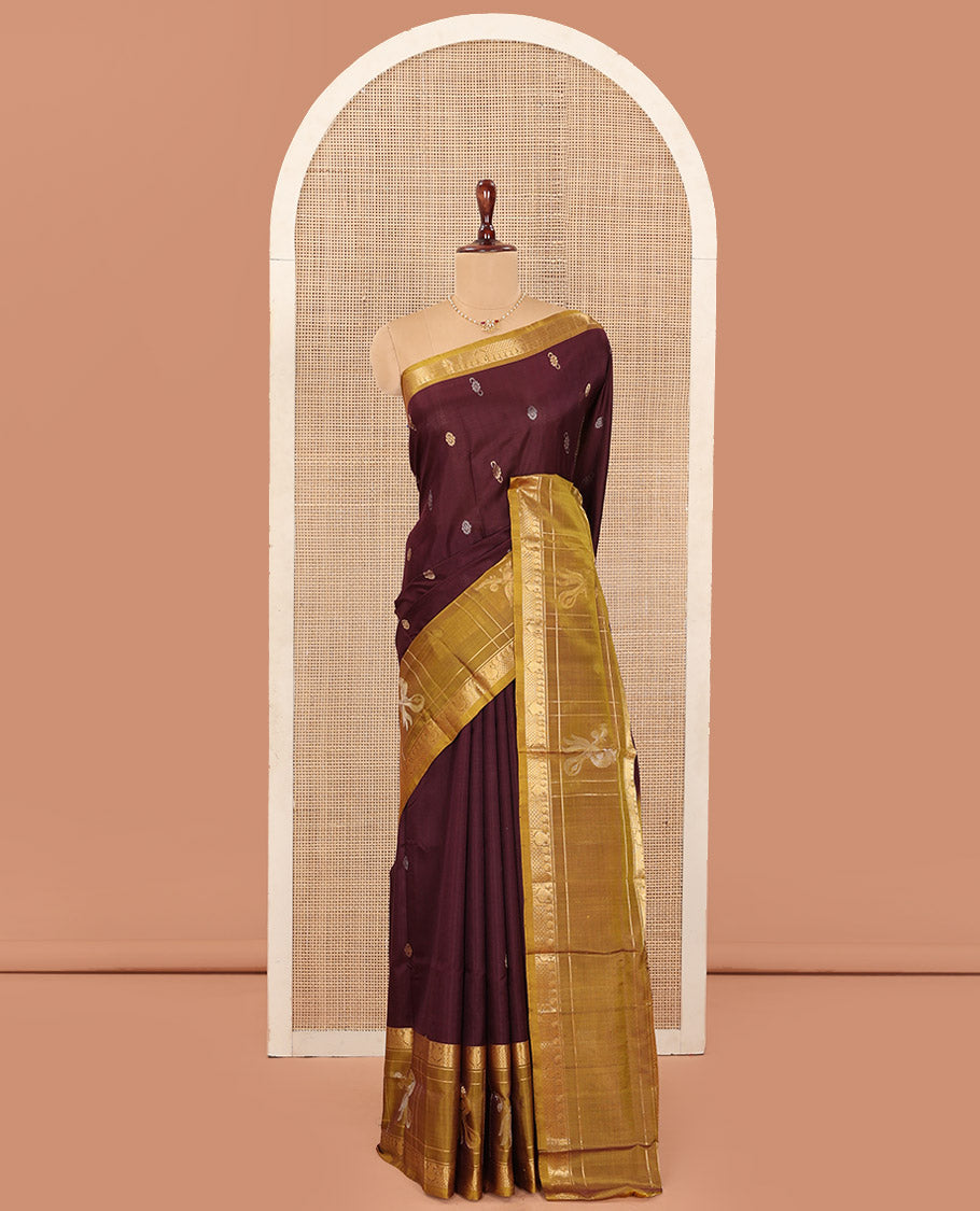 Maroon Uppada Silk Saree Elevated with Zari Buttas All Over Its Body, Complemented by Contrast Traditional Border of Peacock Veenai Designs, Sparsely Woven Pallu of Floral Designs, and Paired with a Contrast Blouse
