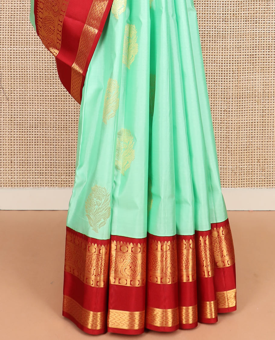 Sea green zari buttas silk saree, contrast korvai rettai pettu border of thilakam, mayil kann, rudraksham, and vanki designs, and jaal pallu