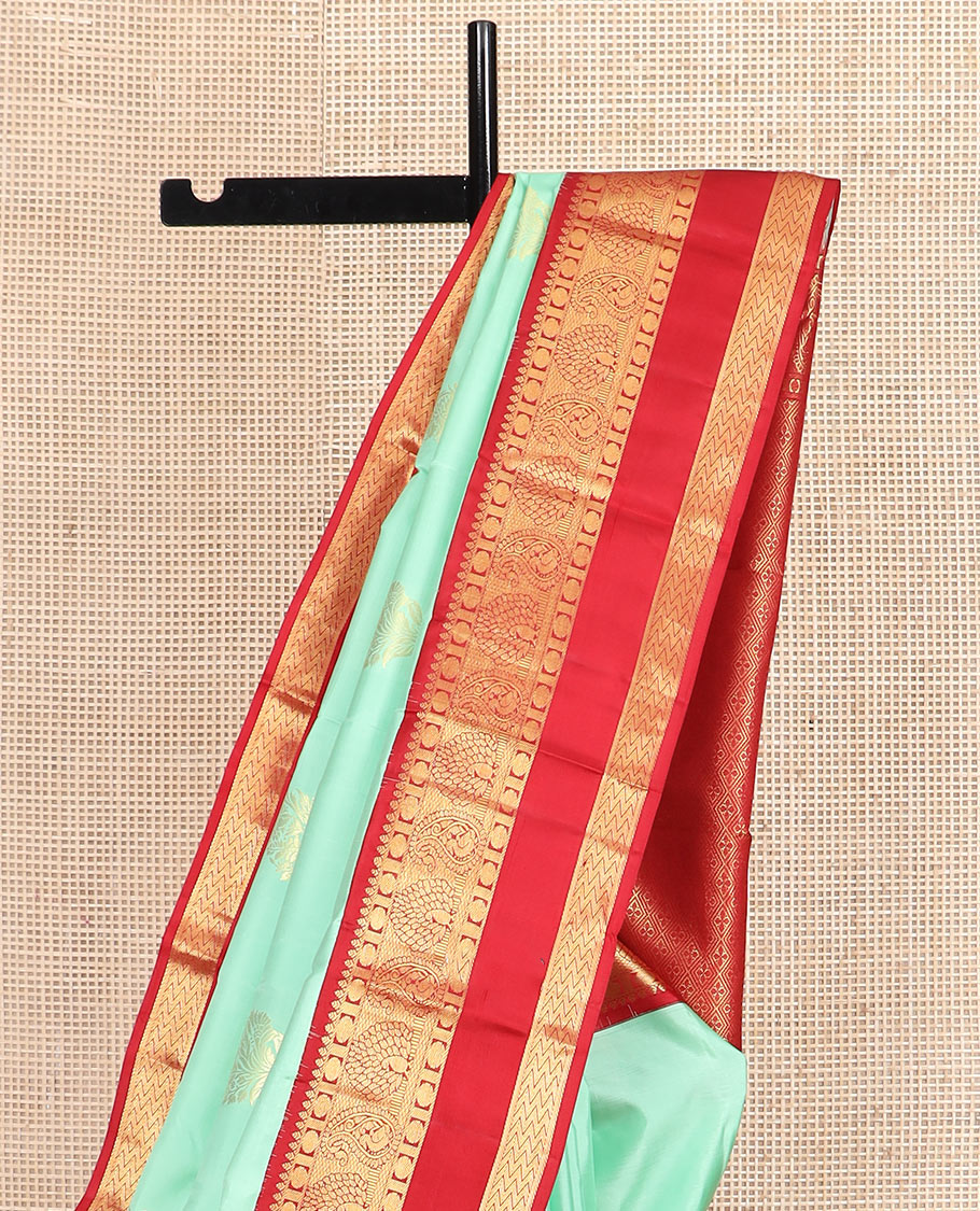 Sea green zari buttas silk saree, contrast korvai rettai pettu border of thilakam, mayil kann, rudraksham, and vanki designs, and jaal pallu