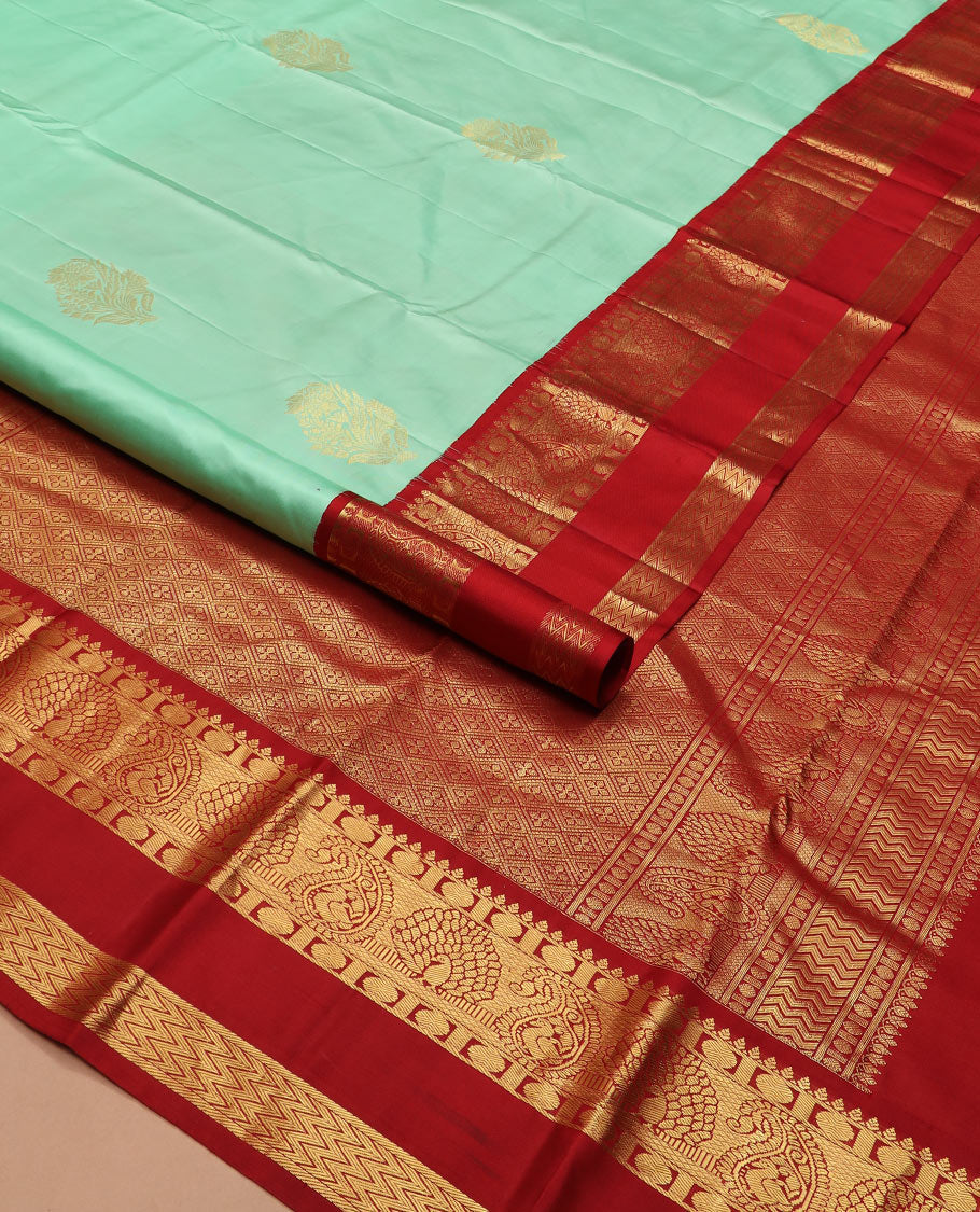 Sea green zari buttas silk saree, contrast korvai rettai pettu border of thilakam, mayil kann, rudraksham, and vanki designs, and jaal pallu