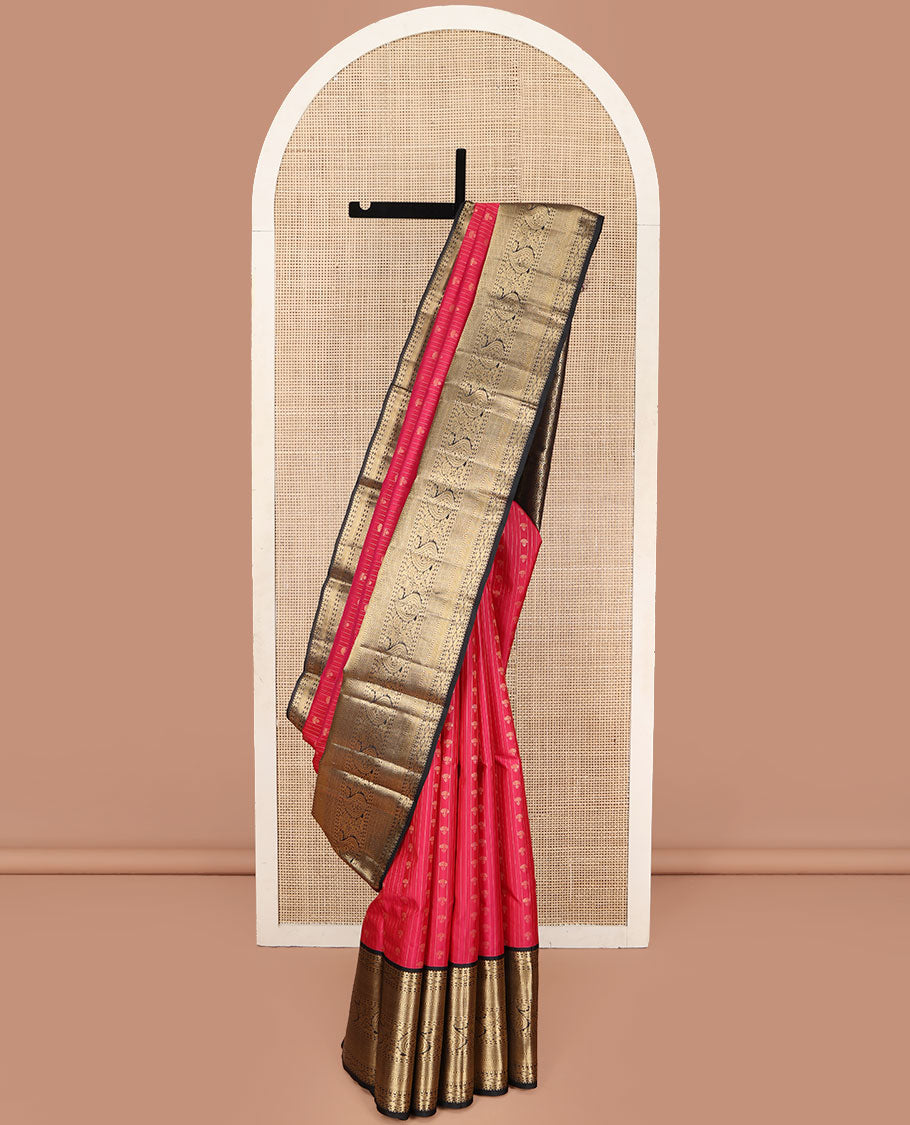 Red Vasundhara Silk Saree, Subtly Sparkled with Buttas and Stripes All Over Its Body, Complemented by Contrast Zari Border of Diamond, Mayil Kann, Manga, and Kodi Visiry Designs, Opulently Embellished Pallu, and Paired with a Contrast Blouse