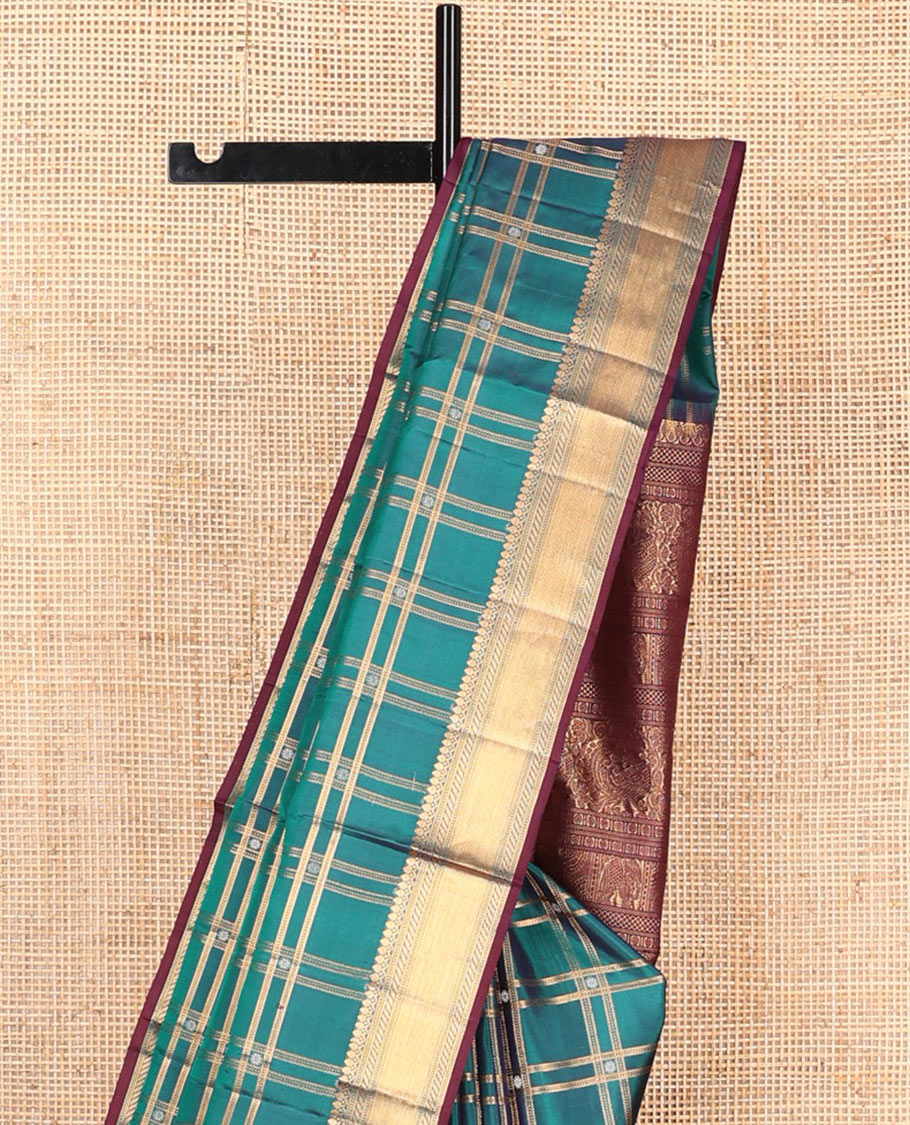 Green butta enclosed checked soft silk saree, zari border of thilakam mokku, banaras, muthu, puli nagam, and vanki designs, and contrast pallu of mayil and yaanai designs