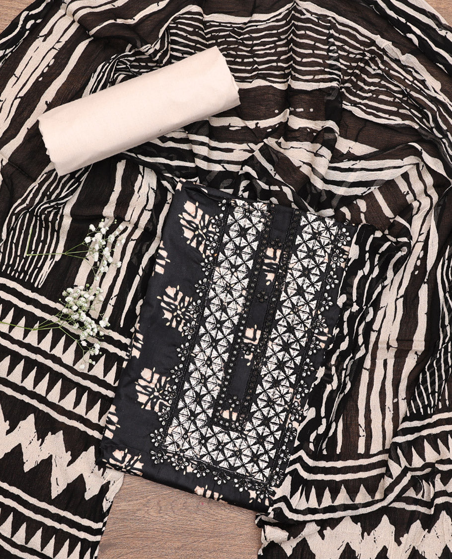 Black Material Chudidar Set, Richly Detailed with Unique Motifs Block Printed and Embroidered on Rayon Top, a Contrast Plain Cotton Bottom, and Paired with a Batik-Style Geometric Printed Chiffon Dupatta