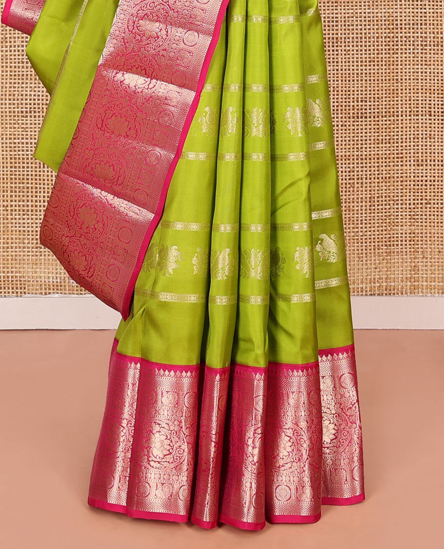 Parrot Green Vasundhara Silk Saree, Artfully Detailed with Zari Designs, Complemented by a Contrast Border of Thilakam Mokku, Muthu, Mayil, Chakra, Kuyil Kann, and Kodi Visiry Designs, Pallu of Floral Jaal Designs, and Paired with a Contrast Blouse