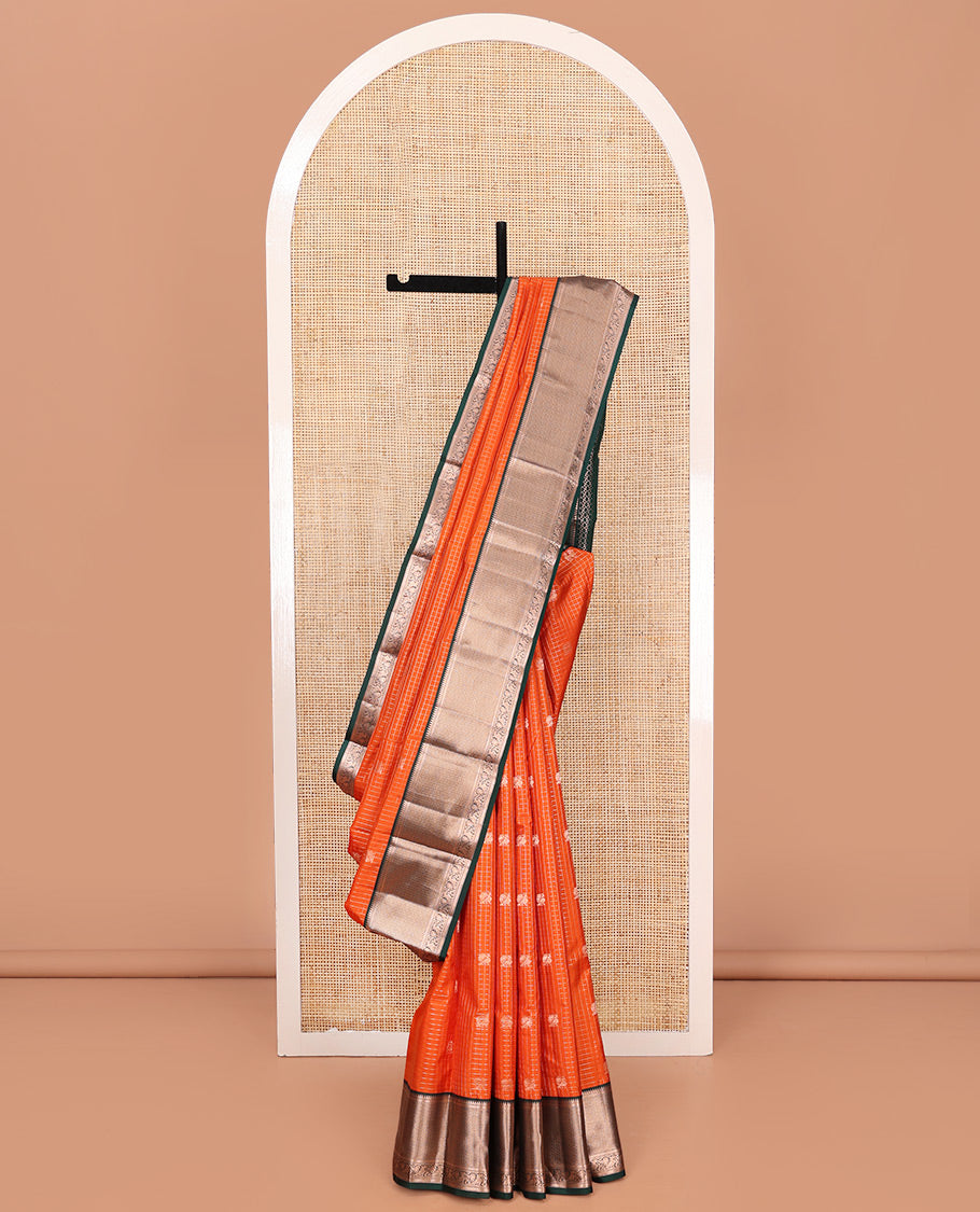 Orange Vasundhara Silk Saree, Embellished with Mayil and Yaali Butta Enclosed Checks on Its Body, Complemented by Contrast Border of Muthu, Rekku, Mayil, and Mayil Kann Designs, Grandly Decked Up Pallu, and Paired with a Contrast Blouse