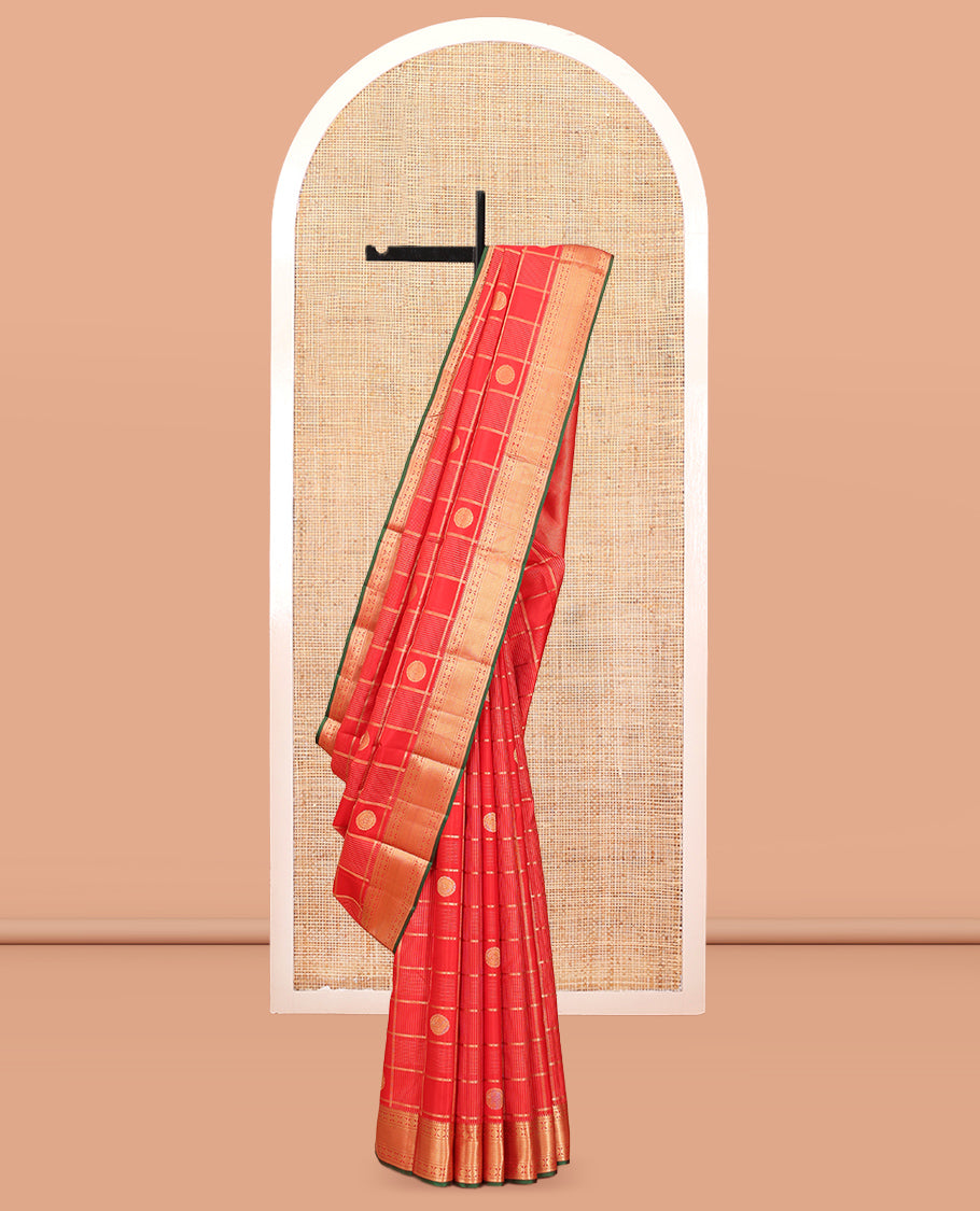 Red Vasundhara Silk Saree, Spotlighted with Chakram Buttas and Checks, a Zari Border of Rekku, and Chakram Designs, a Gleamed Up Pallu, and a Contrast Blouse