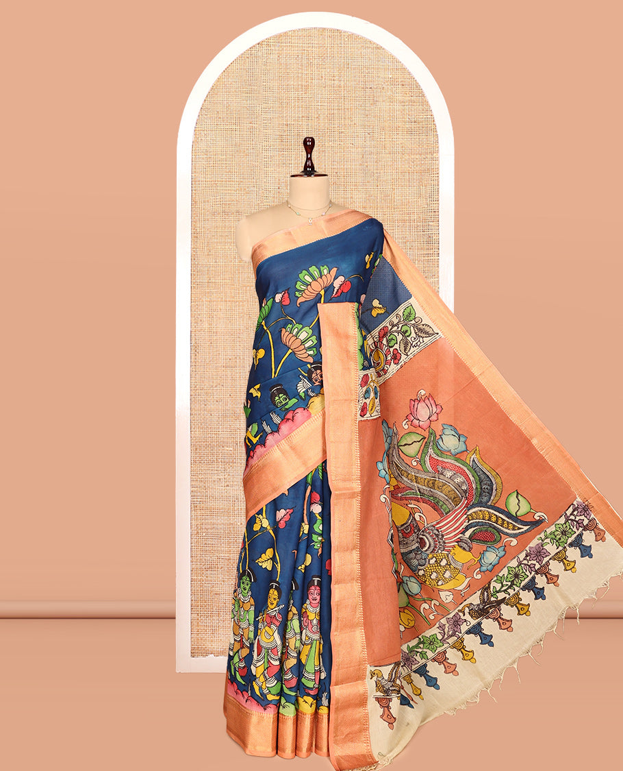 Blue Kalamkari Silk Saree, Opulently Embellished with Floral Vine and Ancient Human Motifs Print, a Contrast Traditional Zari Border, Pallu Features Peacock, and a Contrast Blouse