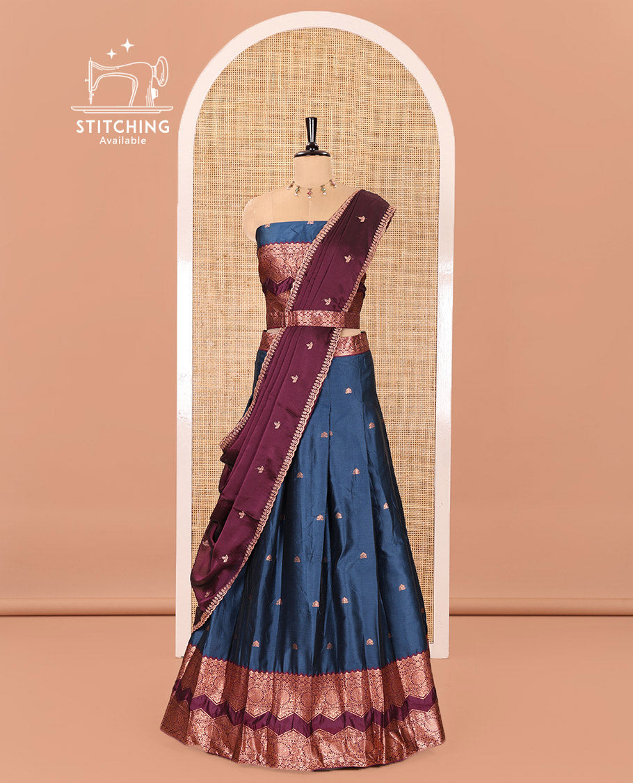 Peacock Blue and Purple Semi-Banarasi Half-Saree Elevated with Zari Buttas on Its Skirt, Complemented by Contrast Traditional Zari Border of Chakram Designs, Paired with a Matching Blouse, and a Satin Georgette Embroidered Scallop Dhavani