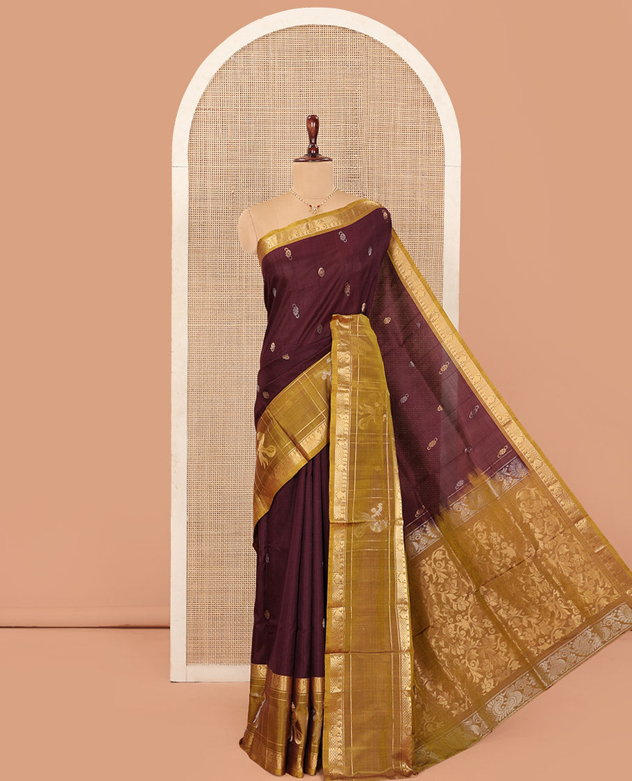 Maroon Uppada Silk Saree Elevated with Zari Buttas All Over Its Body, Complemented by Contrast Traditional Border of Peacock Veenai Designs, Sparsely Woven Pallu of Floral Designs, and Paired with a Contrast Blouse