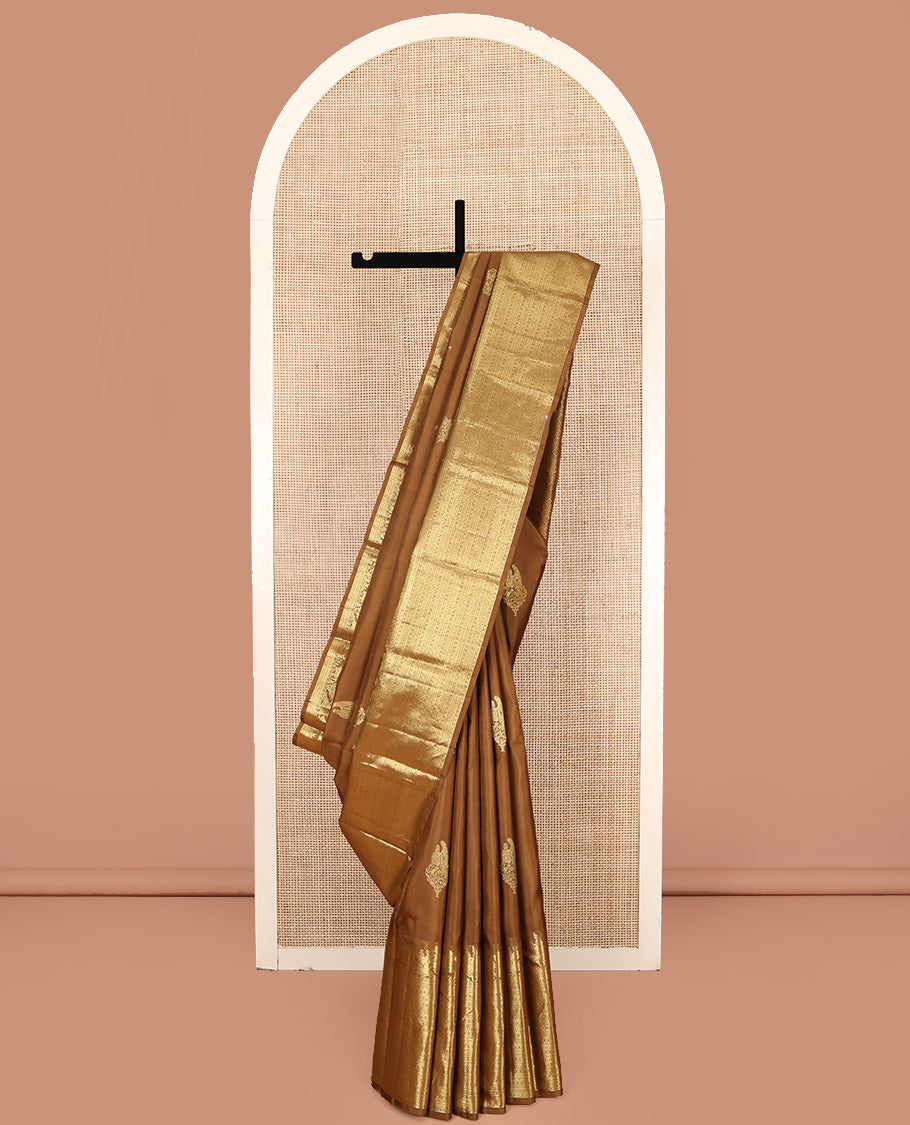 Brown Kanchipuram Silk Saree, Elevated with Zari Buttas All Over Its Body, Highlighted by Zari Wedding-themed Border of Manga, and Kamalam Designs, Grand Jaal Pallu, and Paired with a Matching Blouse