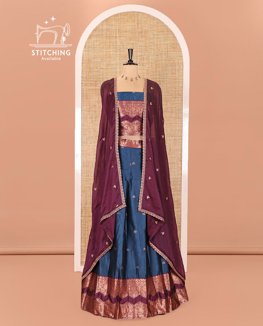 Peacock Blue and Purple Semi-Banarasi Half-Saree Elevated with Zari Buttas on Its Skirt, Complemented by Contrast Traditional Zari Border of Chakram Designs, Paired with a Matching Blouse, and a Satin Georgette Embroidered Scallop Dhavani