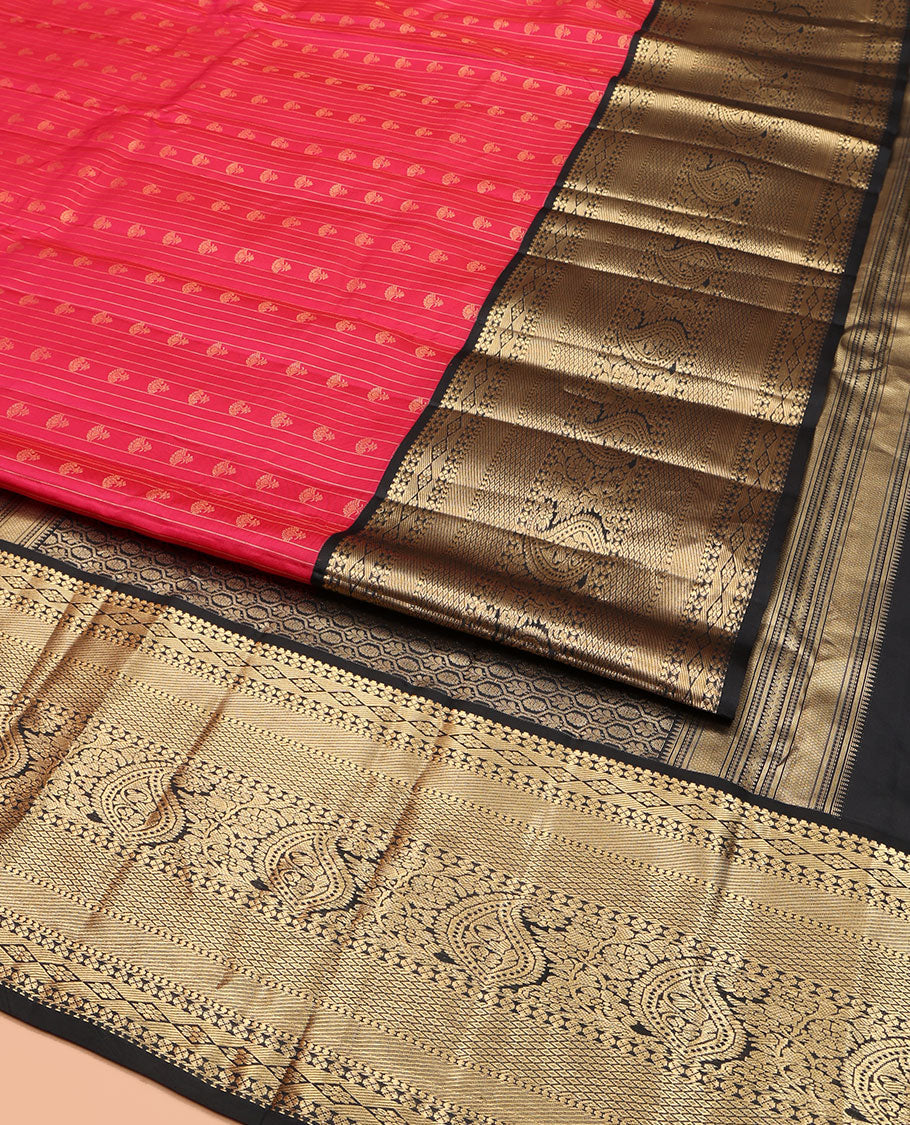 Red Vasundhara Silk Saree, Subtly Sparkled with Buttas and Stripes All Over Its Body, Complemented by Contrast Zari Border of Diamond, Mayil Kann, Manga, and Kodi Visiry Designs, Opulently Embellished Pallu, and Paired with a Contrast Blouse
