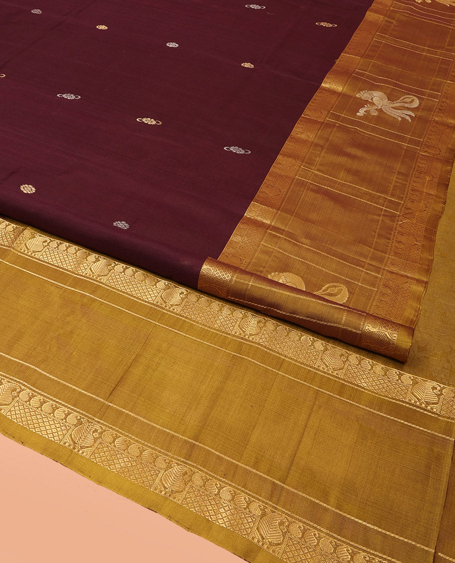 Maroon Uppada Silk Saree Elevated with Zari Buttas All Over Its Body, Complemented by Contrast Traditional Border of Peacock Veenai Designs, Sparsely Woven Pallu of Floral Designs, and Paired with a Contrast Blouse