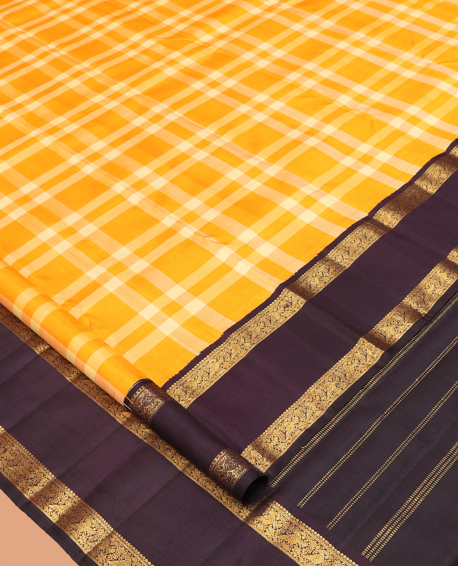 Orange Checked Kanchipuram Silk Saree, Complemented by a Contrast Korvai Rettai Pettu Border of Mayil Designs, Zari Striped Pallu, and a Contrast Blouse
