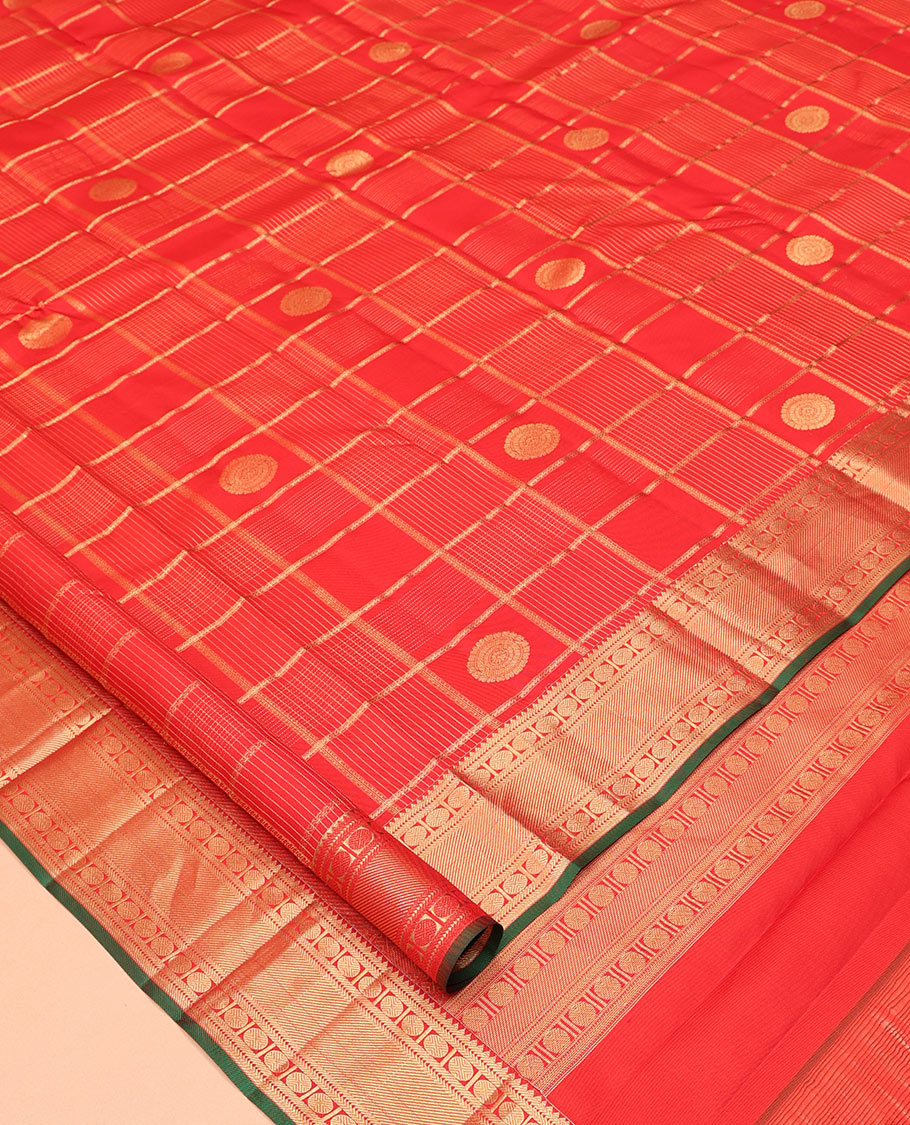 Red Vasundhara Silk Saree, Spotlighted with Chakram Buttas and Checks, a Zari Border of Rekku, and Chakram Designs, a Gleamed Up Pallu, and a Contrast Blouse