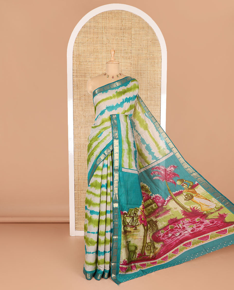 Green shibori printed muslin cotton saree, contrast peacock zari border, village scenery printed pallu, and a contrast polka dotted zari border blouse