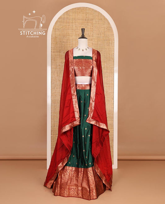 Dark green taffeta silk half saree, zari buttas with contrast red traditional zari border, matching zari blouse, and contrast plain zari border dhavani