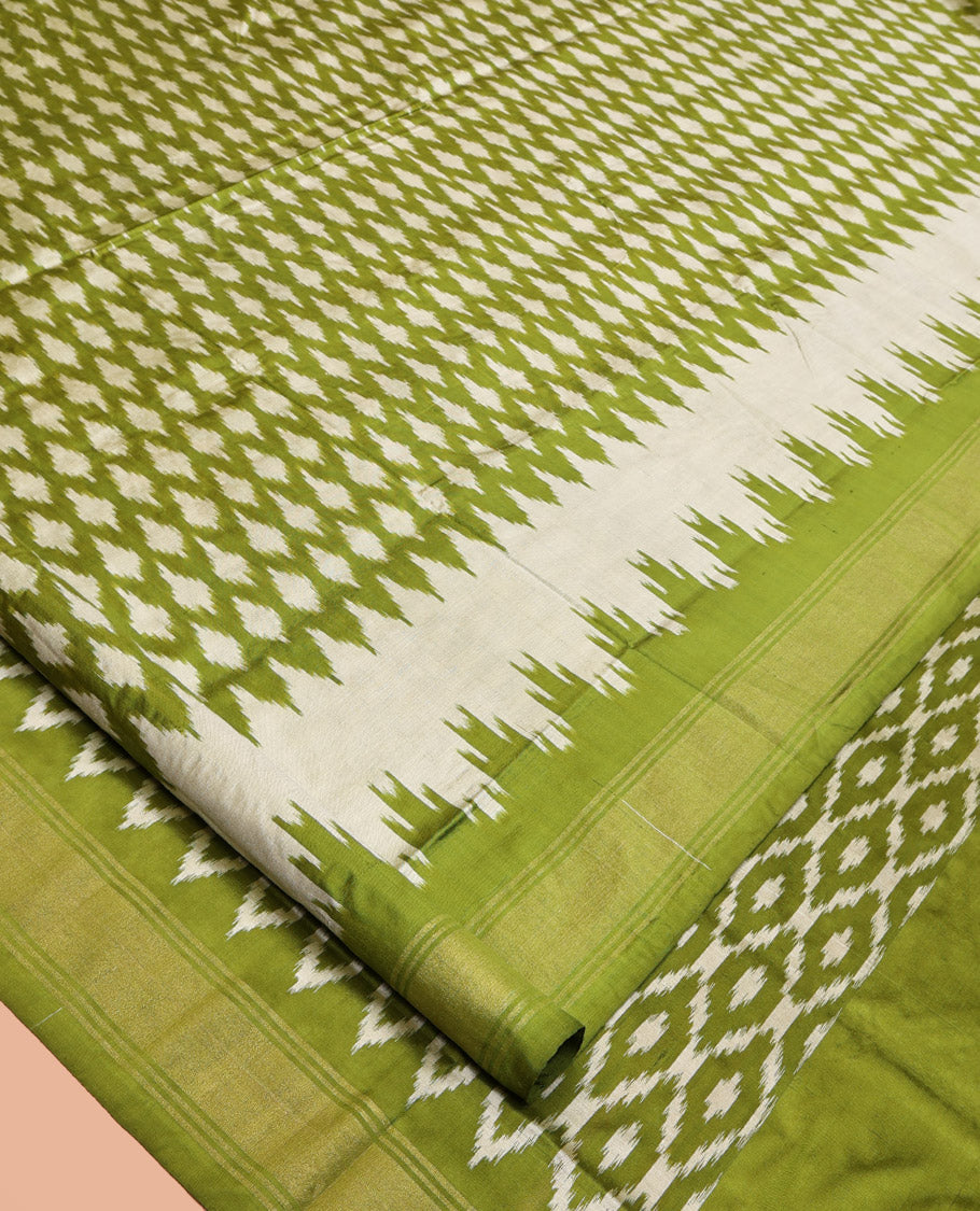 Green Pochampally Ikat Silk Saree, Elevated with Ikkat Buttas on Its Body, Complemented by a Ikkat-Style Woven Temple Border, Pallu of Ogee Patterns, and Paired with a Matching Blouse