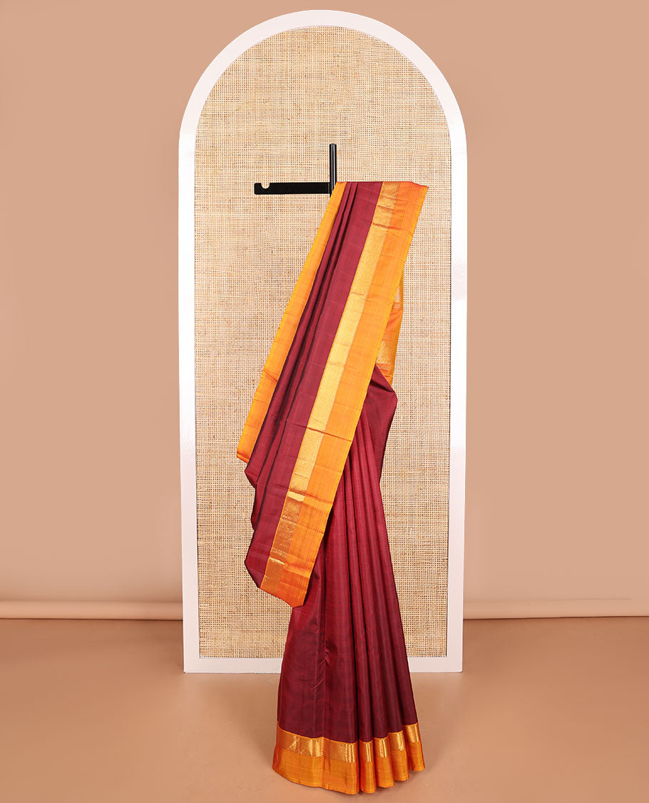 Maroon kancheepuram silk saree withcontrast zari border & striped pallu