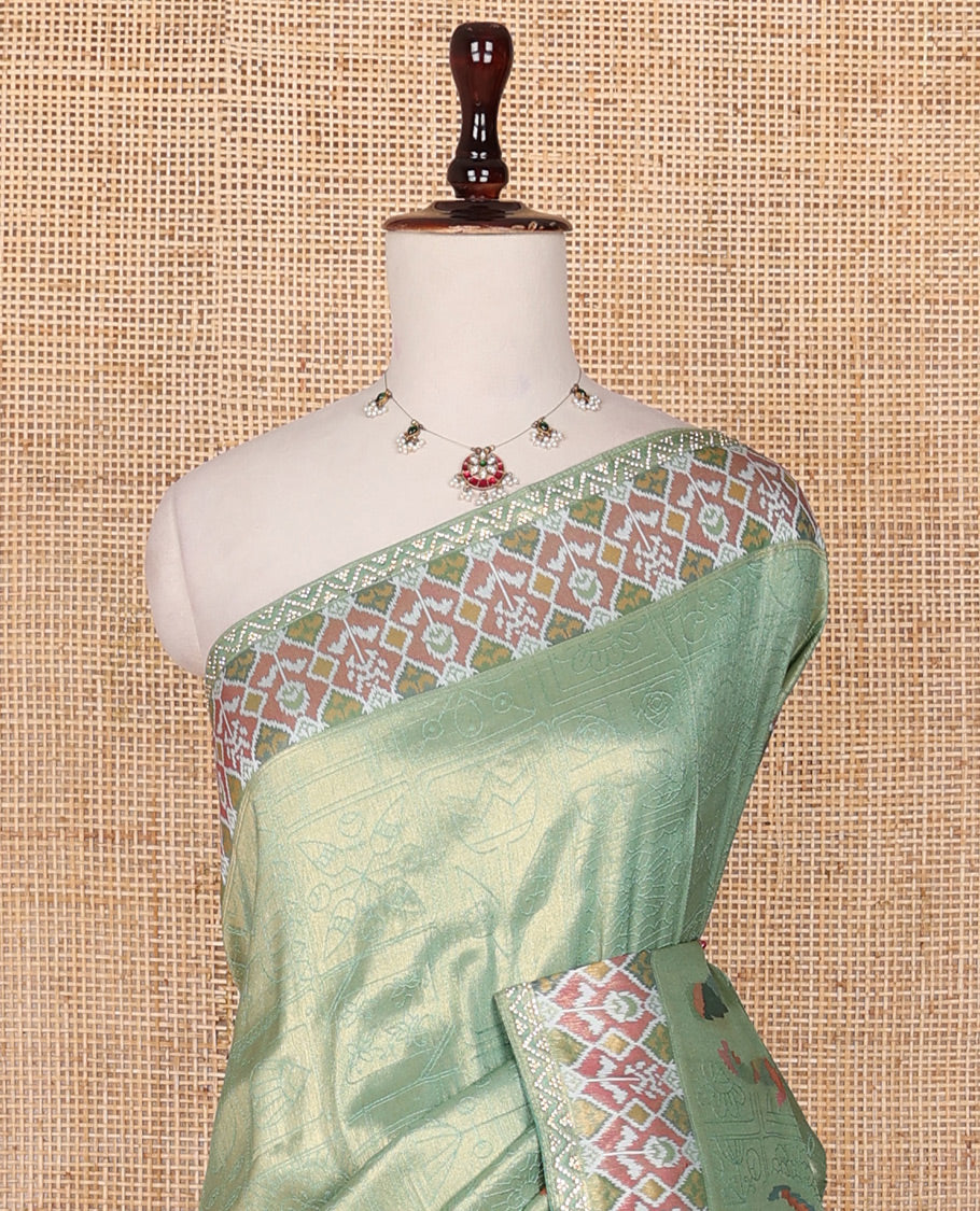 Green butta enclosed buttas designer saree, ikkat diamond patterned stone work border, and ikkat peacock printed pallu