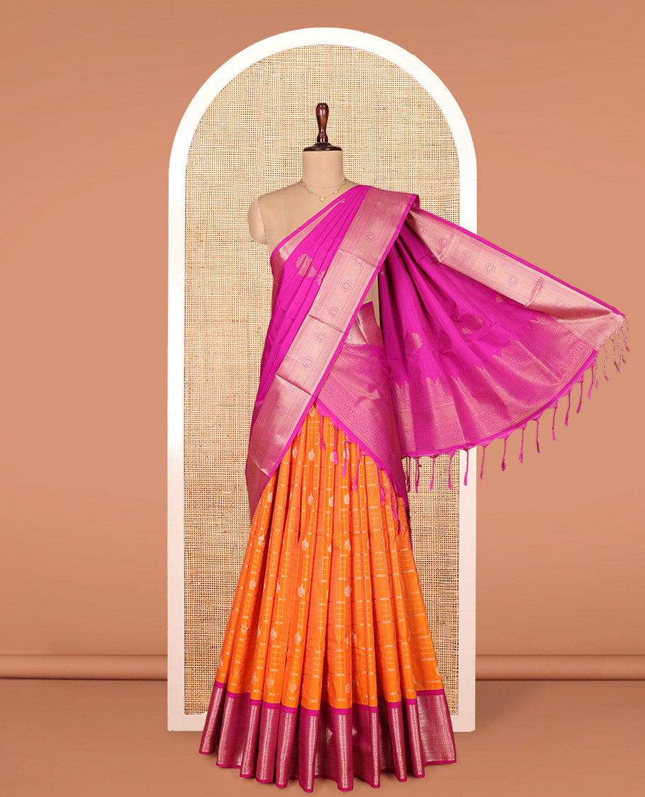Orange Art Silk Material Half Saree Set, Decked Up with Zari Buttas Enclosed Checks on Its Skirt, Complemented by Contrast Traditional Zari Design Border, Paired with a Contrast Blouse, and an Intricately Designed Dhavani