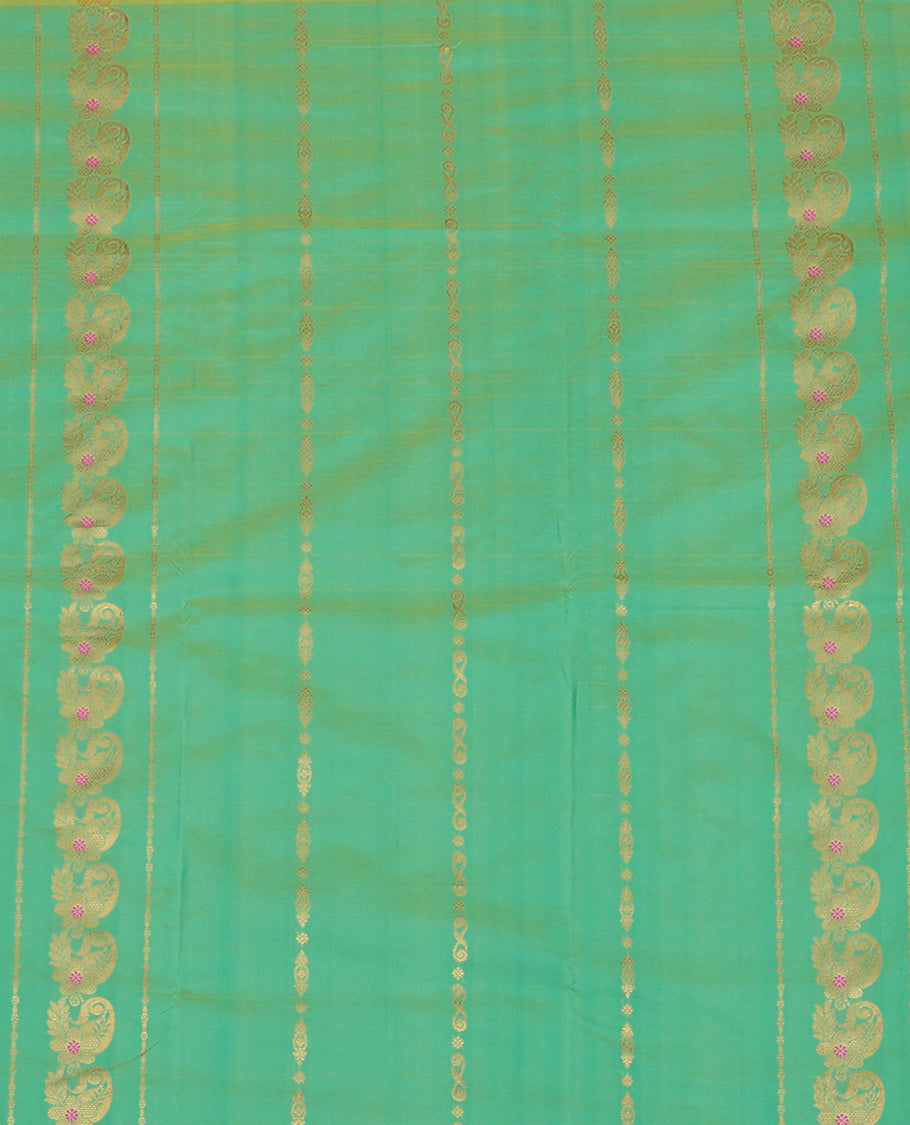Green Art Silk Pavadai Material Set, Delicately Woven with Zari Designs on Its Skirt, Complemented by a Contrast Paisley Zari Border, and a Matching Blouse