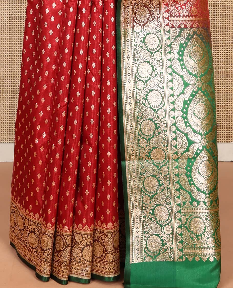 Red Semi-Banaras Saree, Richly Detailed with Zari Buttas on Its Body, Complemented by a Contrast Floral -Paisley Creeper Design Border, Intricately Designed Pallu, and Paired with a Contrast Blouse