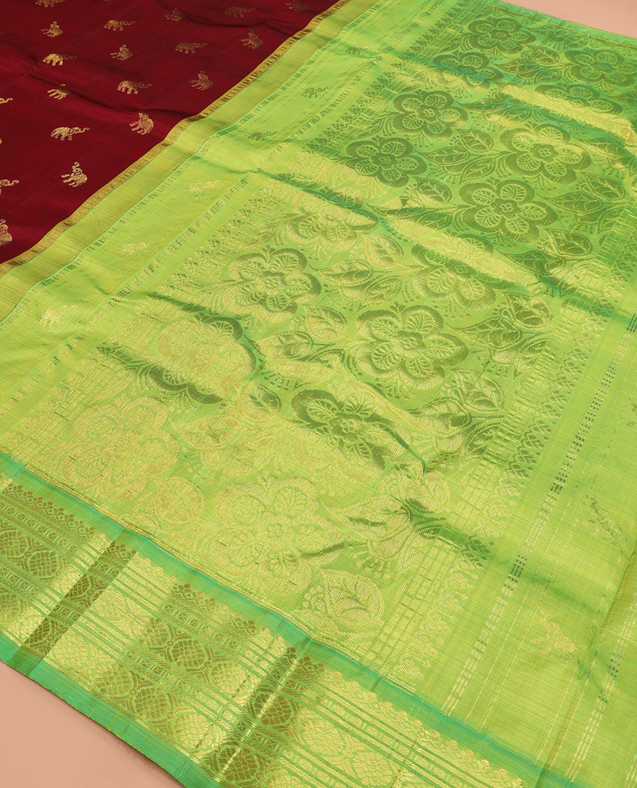 Maroon yaanai buttas Kanchipuram silk saree, contrast thazampoo rekku checked border of salngai, banaras, lavangam, and laddu kamalam designs, and floral design pallu