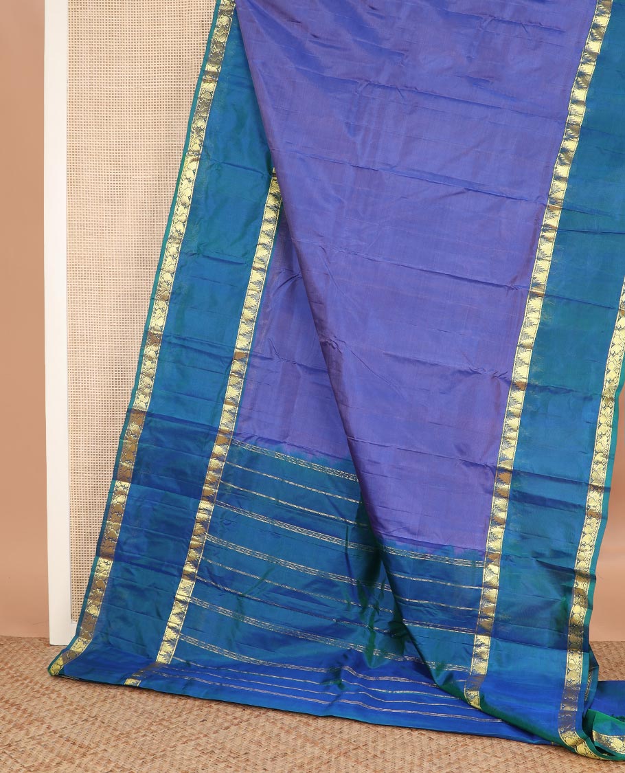 Blue plain Kanchipuram silk saree, contrast rettai pettu border of thazampoo rekku, manga, and mayil designs, and zari striped pallu