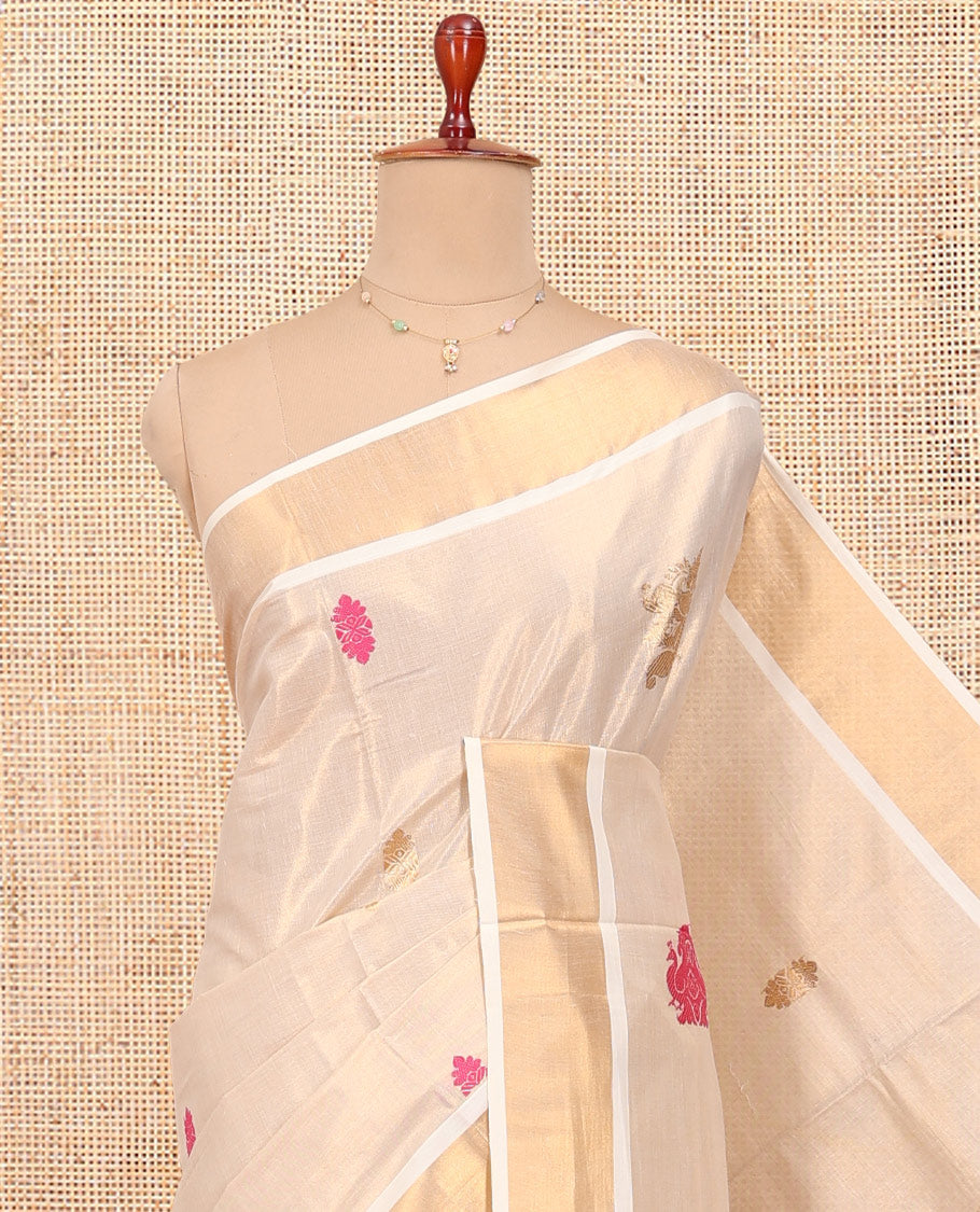 Cream Kerala Cotton Saree, Spotlighted with Thread and Zari Buttas All Over Its Body, a Zari Bavanji Border, Pallu of Elephant Designs, and Paired with a Matching Blouse
