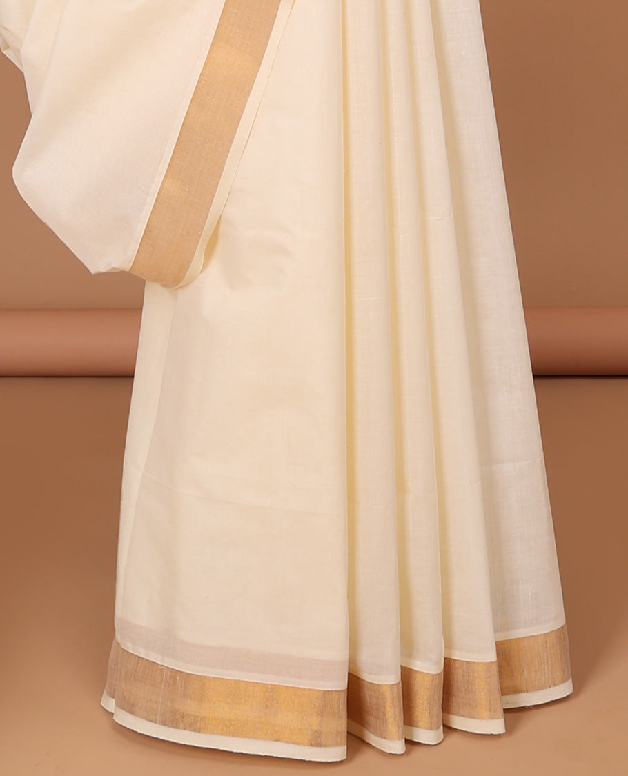 Cream kerala saree with zari stripes, zari border & pallu of peacocks