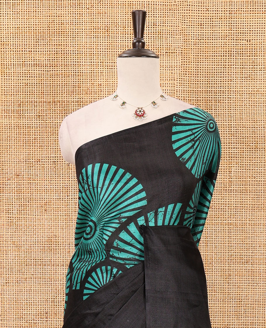 Black-base plain body khadi cotton saree with batik-style green-color radiant sunburst design on its border & pallu, plain black blouse
