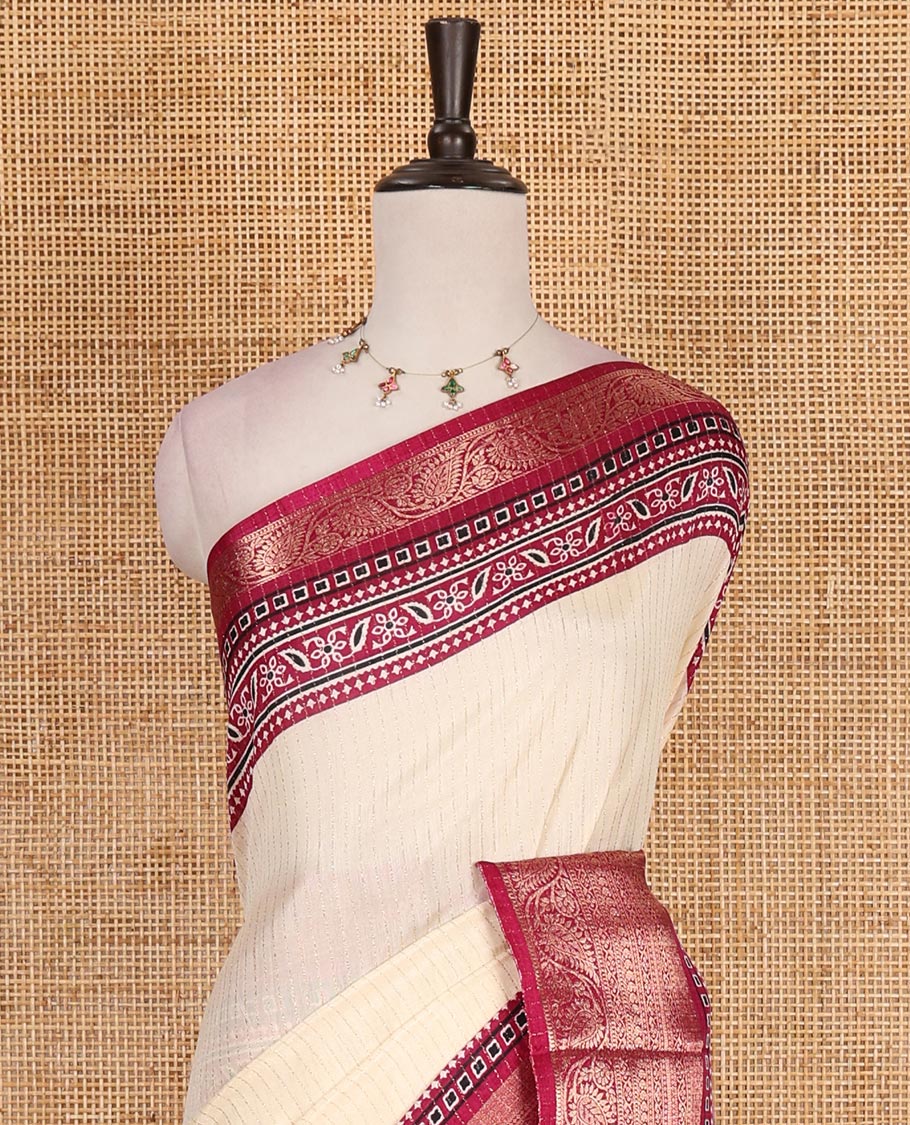Cream-magenta zari striped dola silk saree, contrast traditional zari border of leaf creeper, Ajrakh printed pallu, and Ajrakh printed blouse