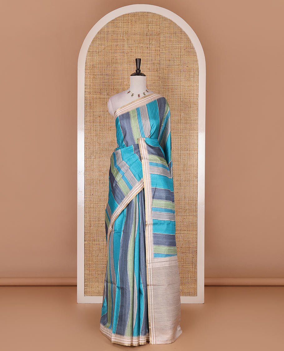 Multi color vertically striped semi-tussar saree, contrast resham thread border of temple and rudraksham motifs, striped pallu, and contrast striped printed blouse