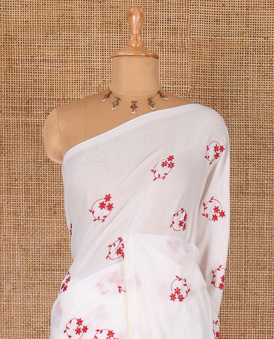Borderless white and red floral motifs embroidered Khadi mul cotton saree with a matching plain blouse