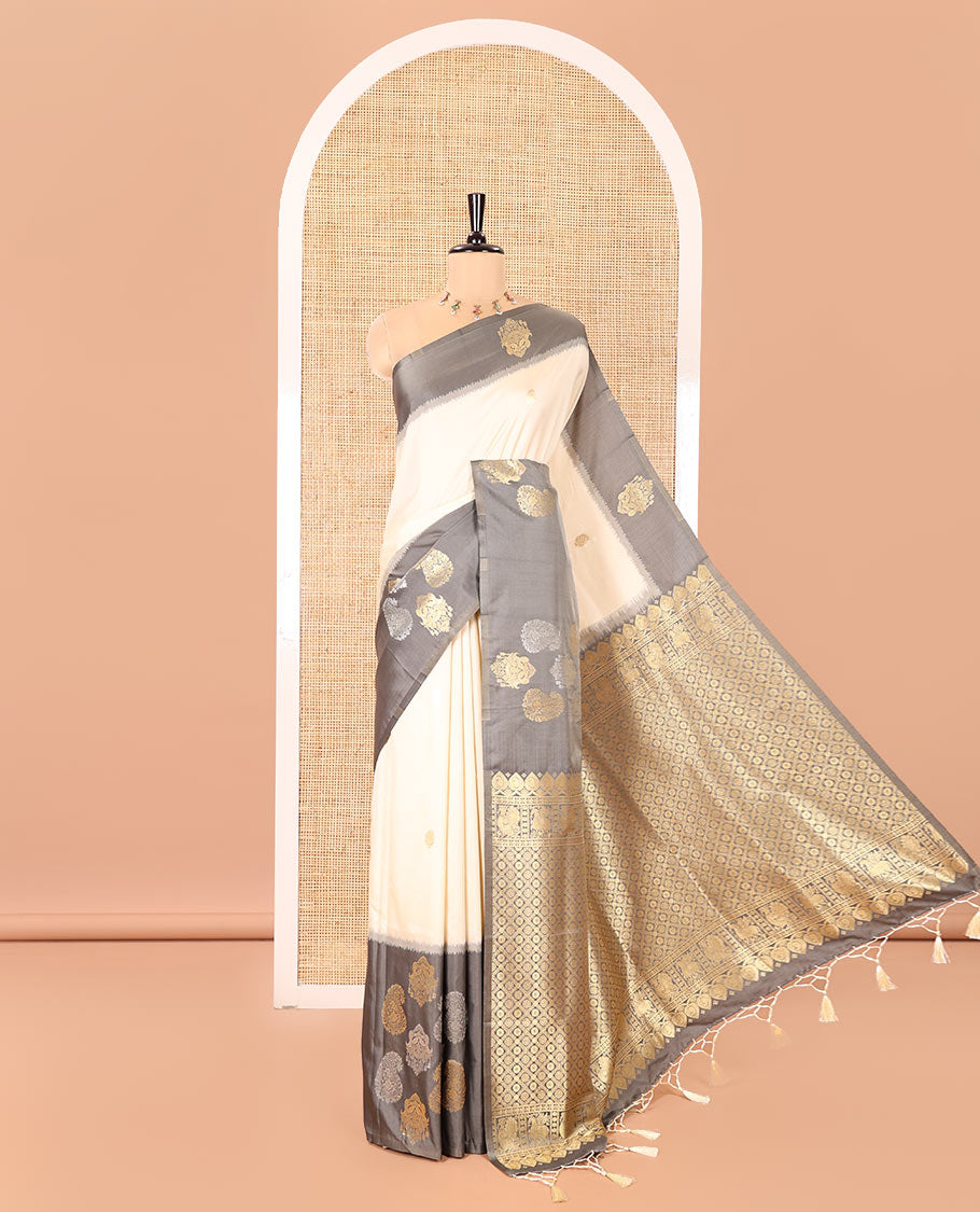 Cream Elite Soft Silk Saree, Accentuated with Zari Buttas All Over Its Body, Complemented by Contrast Border Steeped with Zari Buttas, Grand Jaal Design Pallu, and Paired with a Contrast Blouse