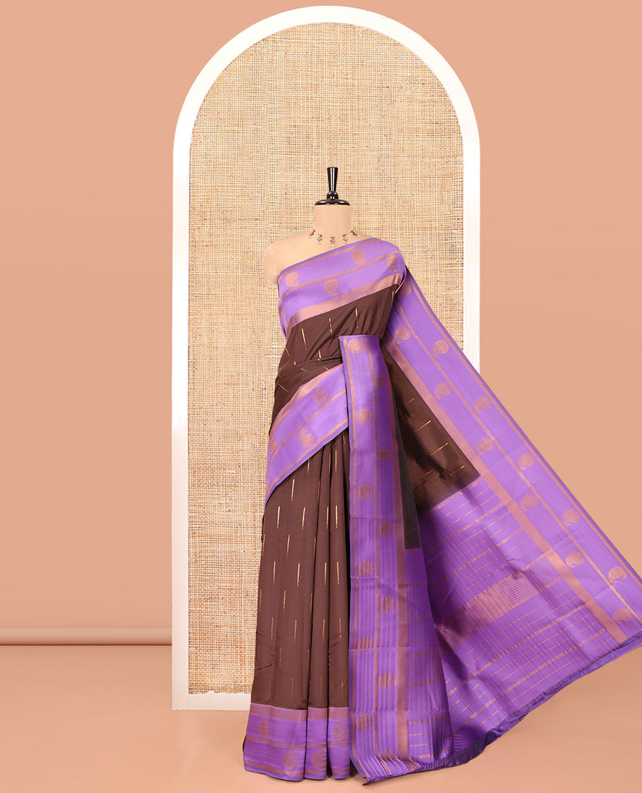 Brown and Lavender Kanchi Silk Saree, Adorned with Zari Buttas All Over Its Body, Complemented by a Contrast Border of Paisleys, Zari-Striped Pallu, and Paired with a Contrast Jacquard Blouse