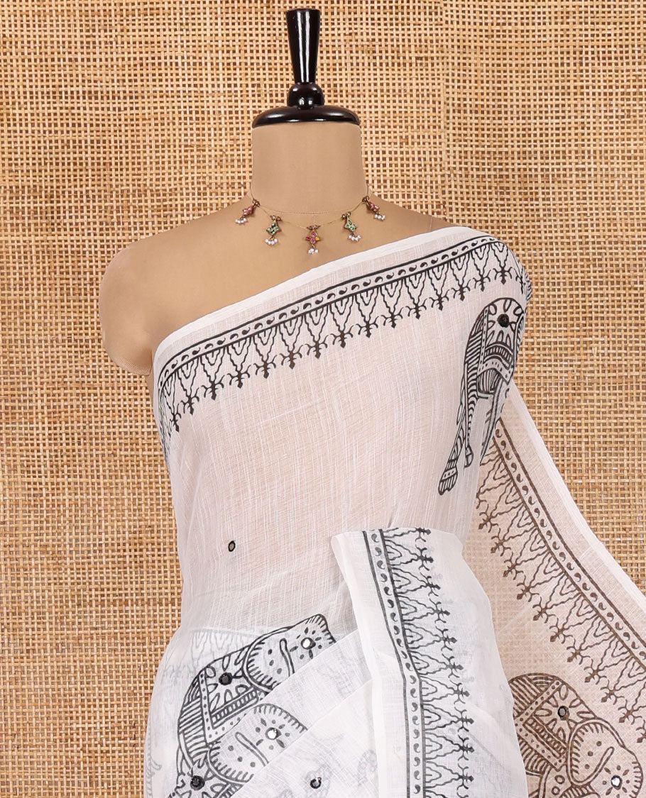 White Linen Cotton Saree Features Elephant Print and Mirrorwork, a Temple Border, a Self-Pallu, and a Contrast Blouse