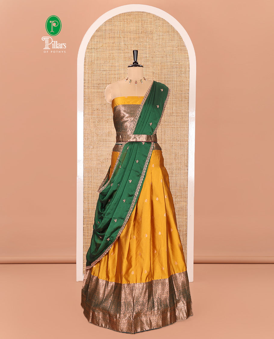 Yellow and Green Semi-Banarasi Half-Saree Beautified with Zari Buttas on Its Skirt, Complemented by a Contrast Traditional Zari Design Steeped Border, Paired with a Matching Blouse, and a Satin Georgette Embroidered Scallop Dhavani