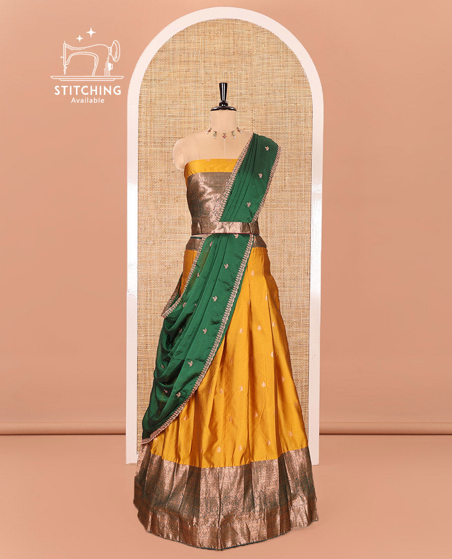 Yellow and Green Semi-Banarasi Half-Saree Beautified with Zari Buttas on Its Skirt, Complemented by a Contrast Traditional Zari Design Steeped Border, Paired with a Matching Blouse, and a Satin Georgette Embroidered Scallop Dhavani