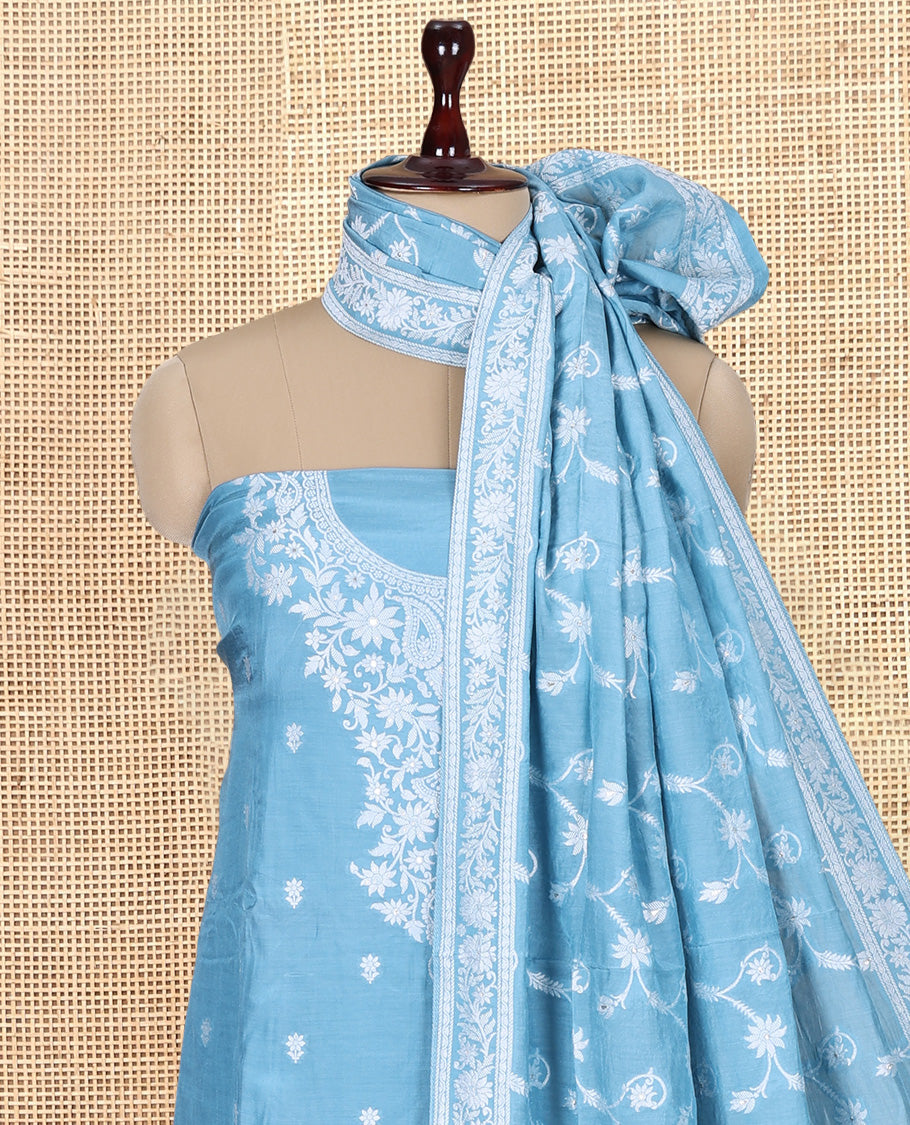 Sea Blue Viscose Muslin Material Churidar Features Buttas Thread Woven Top, a Santoon Bottom, and Floral Jaal Dupatta