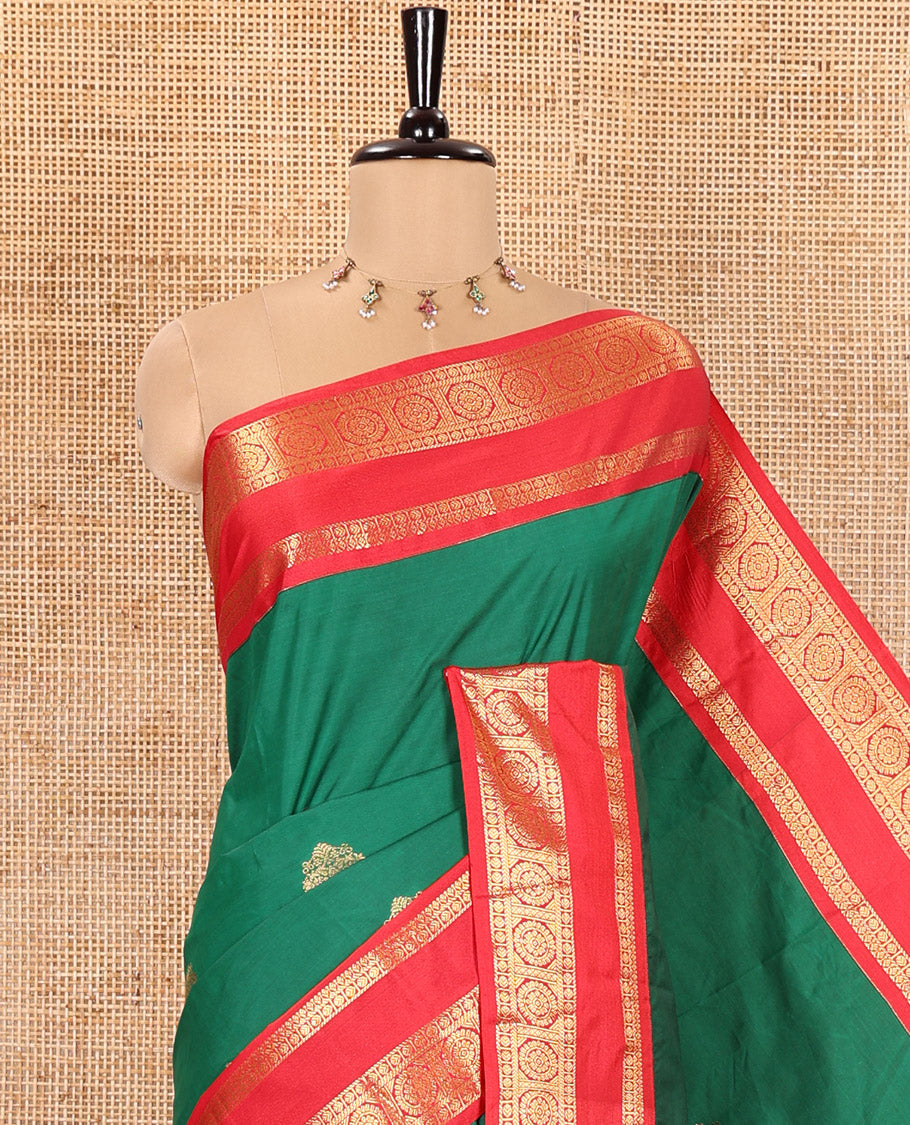 Green Kanchipuram Budget Silk Saree, Detailed with Zari Buttas All Over Its Body, Complemented by a Contrast Traditional Zari Rettai Pettu Border of Chakram Designs, Gracefully Embellished Pallu, and Paired with a Contrast Blouse